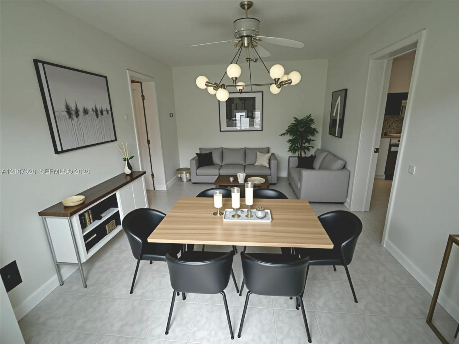 Multi-bulb modern chandelier, neutral tile flooring, and built-in white cabinetry with a wood-finish top