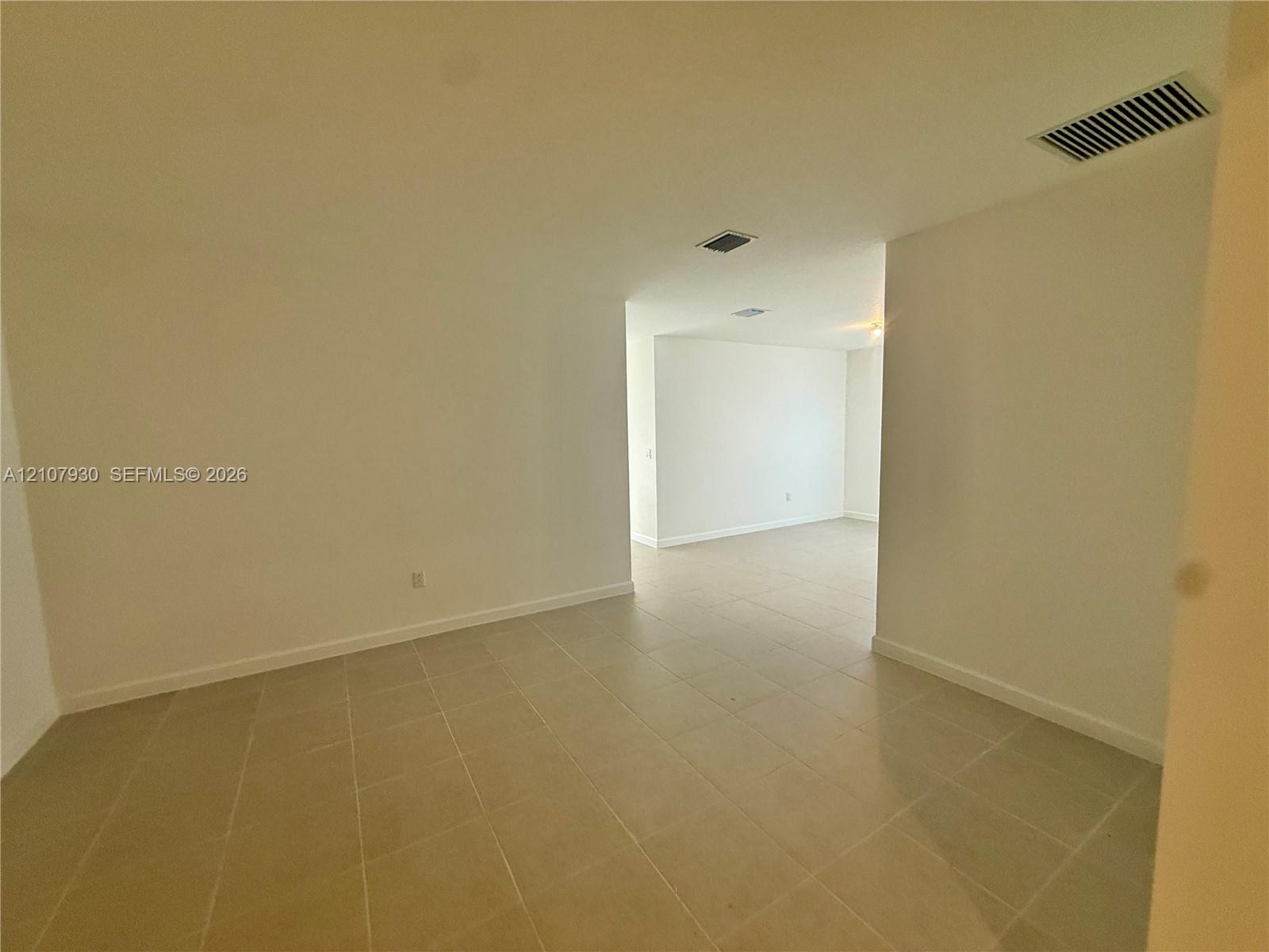 Neutral-toned ceramic tile flooring throughout the interior, complemented by smooth walls and high ceilings Neutral-toned ceramic tile flooring throughout the interior, complemented by smooth walls and high ceilings