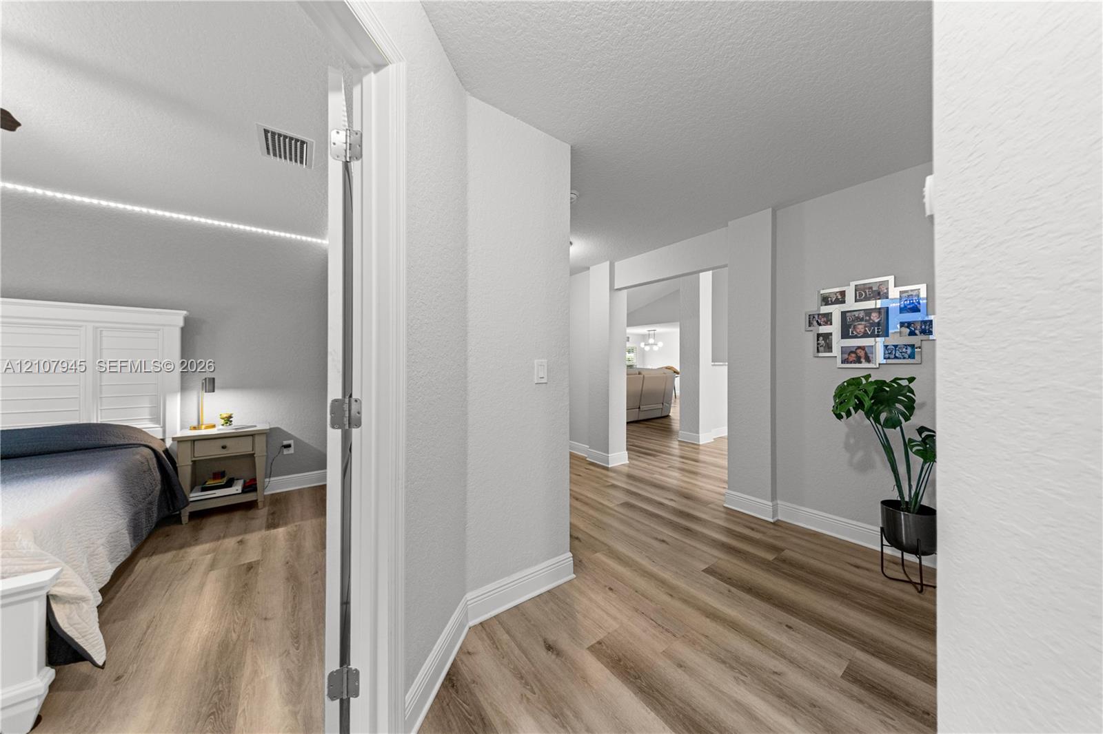 Wood-finish flooring and neutral wall paint throughout an open interior layout with wide doorways