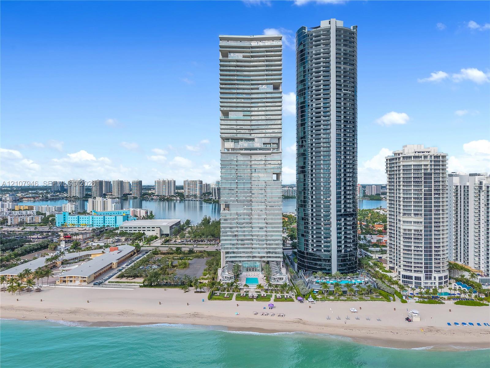 High-rise residential towers featuring floor-to-ceiling glass facades, direct beach access, and ground-level outdoor swimming pools High-rise residential towers featuring floor-to-ceiling glass facades, direct beach access, and ground-level outdoor swimming pools