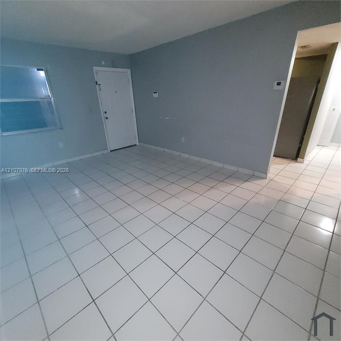 Neutral-toned walls paired with large-format square tile flooring