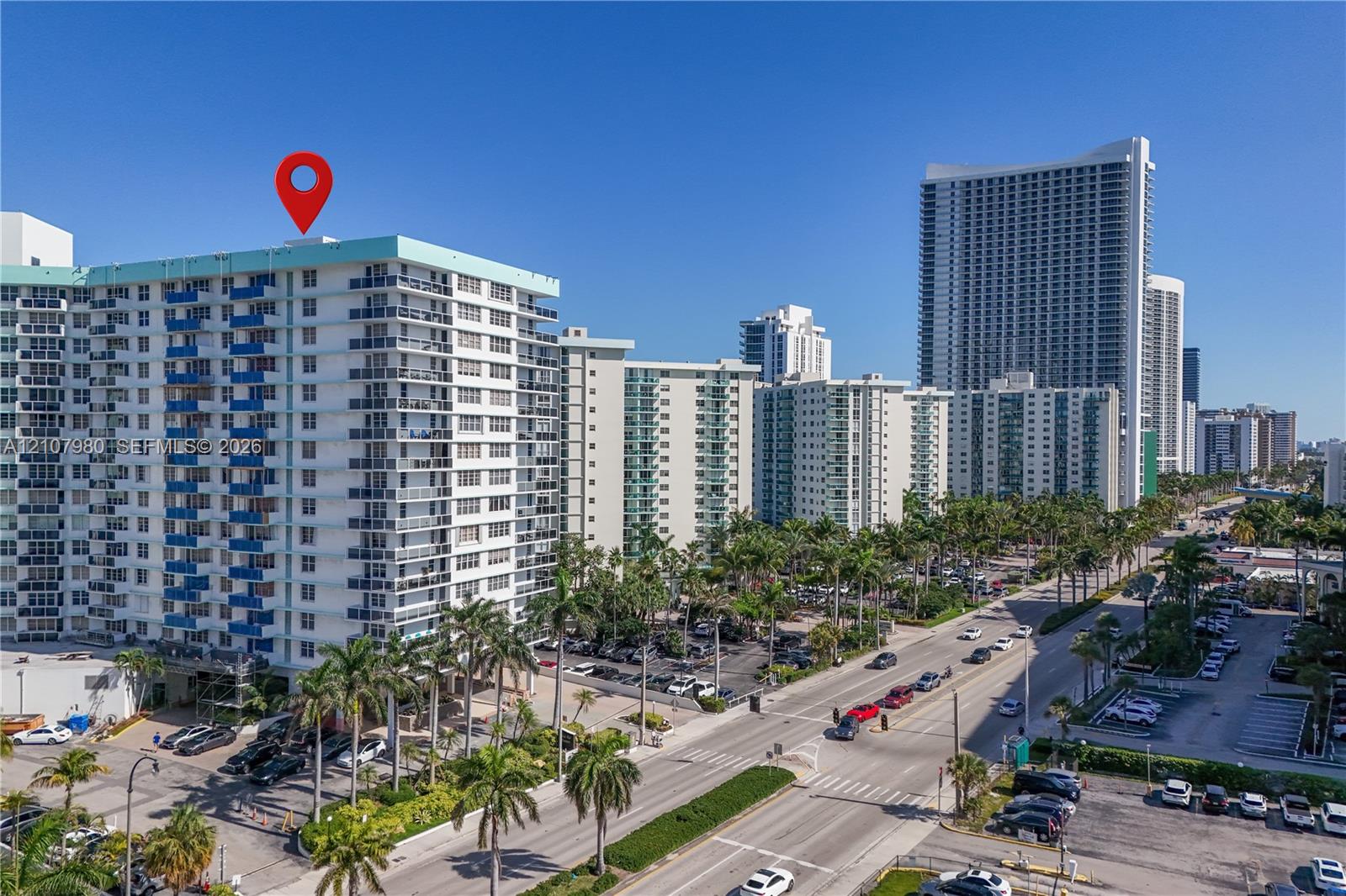 High-rise residential exterior featuring private balconies, integrated concrete construction, and mature palm tree landscaping