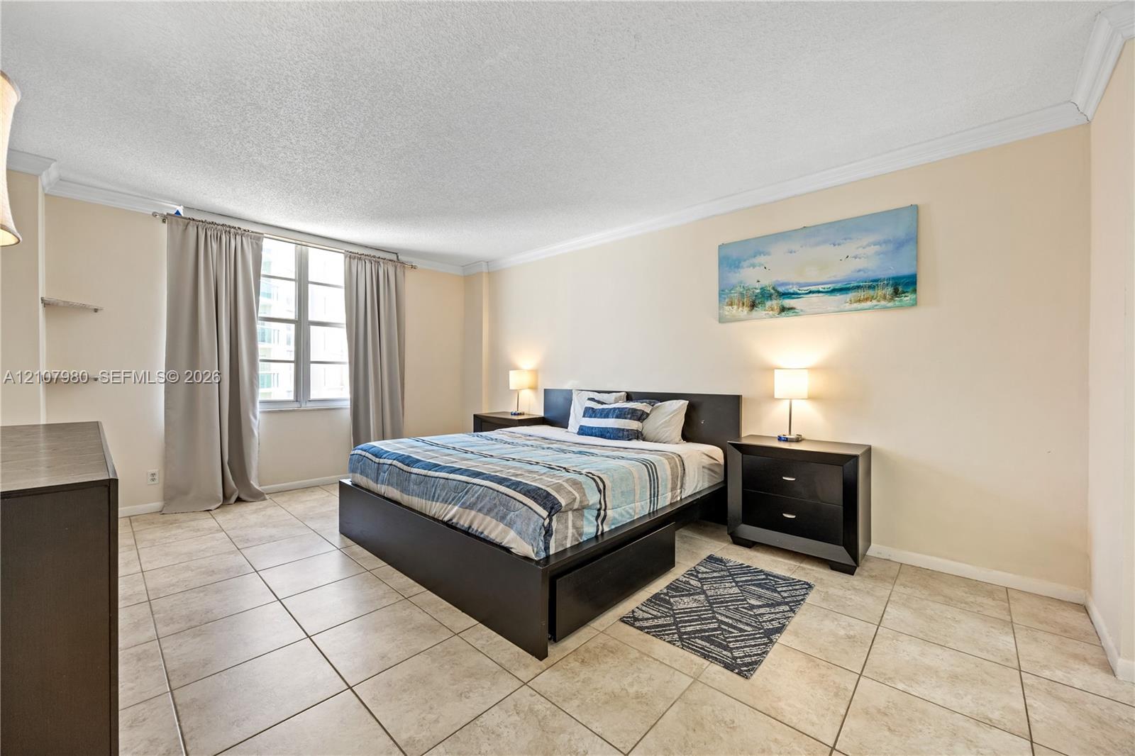 Neutral-toned ceramic tile flooring, multi-panel window, crown molding, and built-in wall shelving