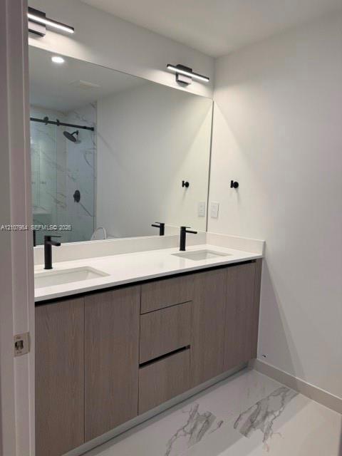 Dual-sink vanity with matte black fixtures, quartz countertop, wood-finish cabinetry, and full-width mirror, featuring a walk-in shower with stone-patterned tile surround Dual-sink vanity with matte black fixtures, quartz countertop, wood-finish cabinetry, and full-width mirror, featuring a walk-in shower with stone-patterned tile surround