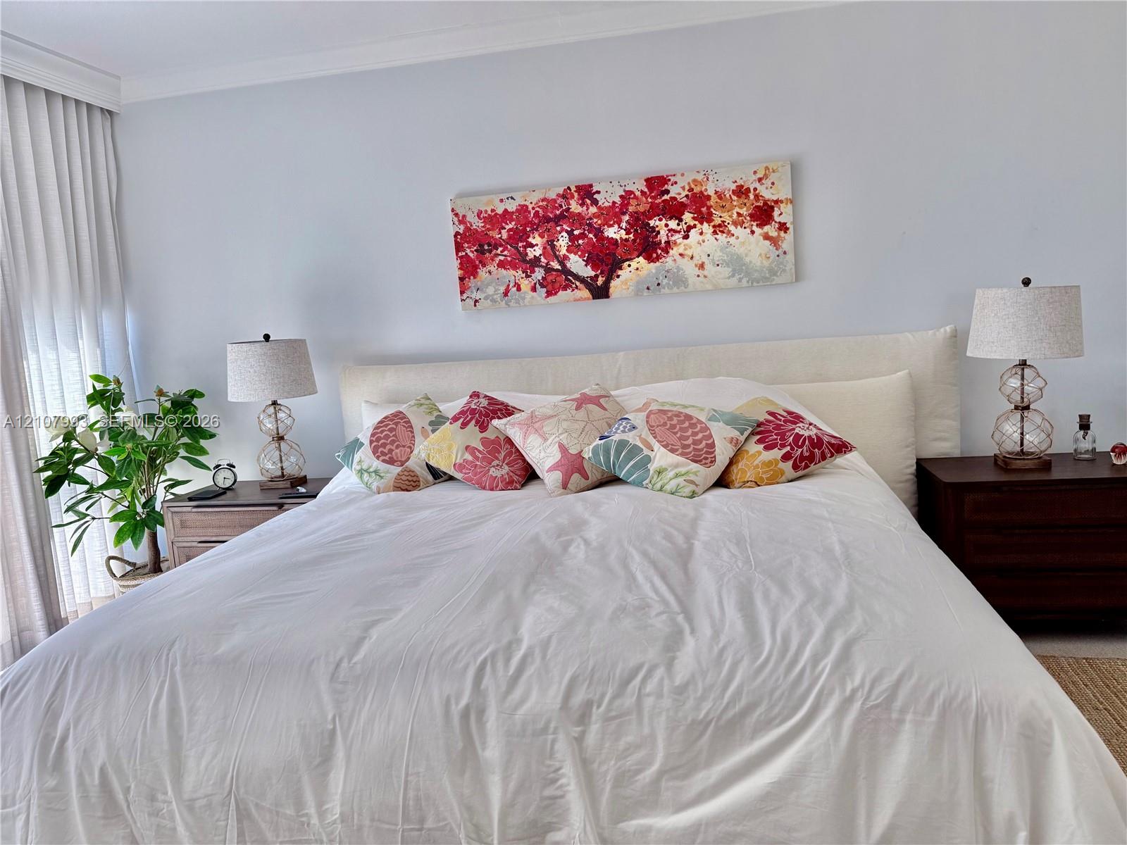 Floor-to-ceiling pleated window treatments and crown molding