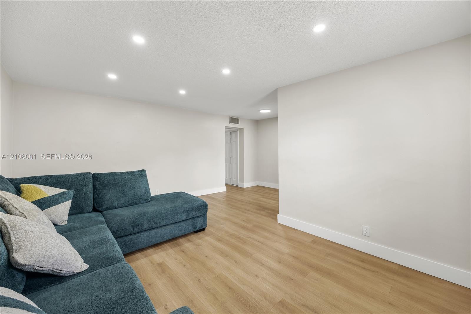 Interior space featuring wood-finish flooring, recessed lighting, and neutral wall paint