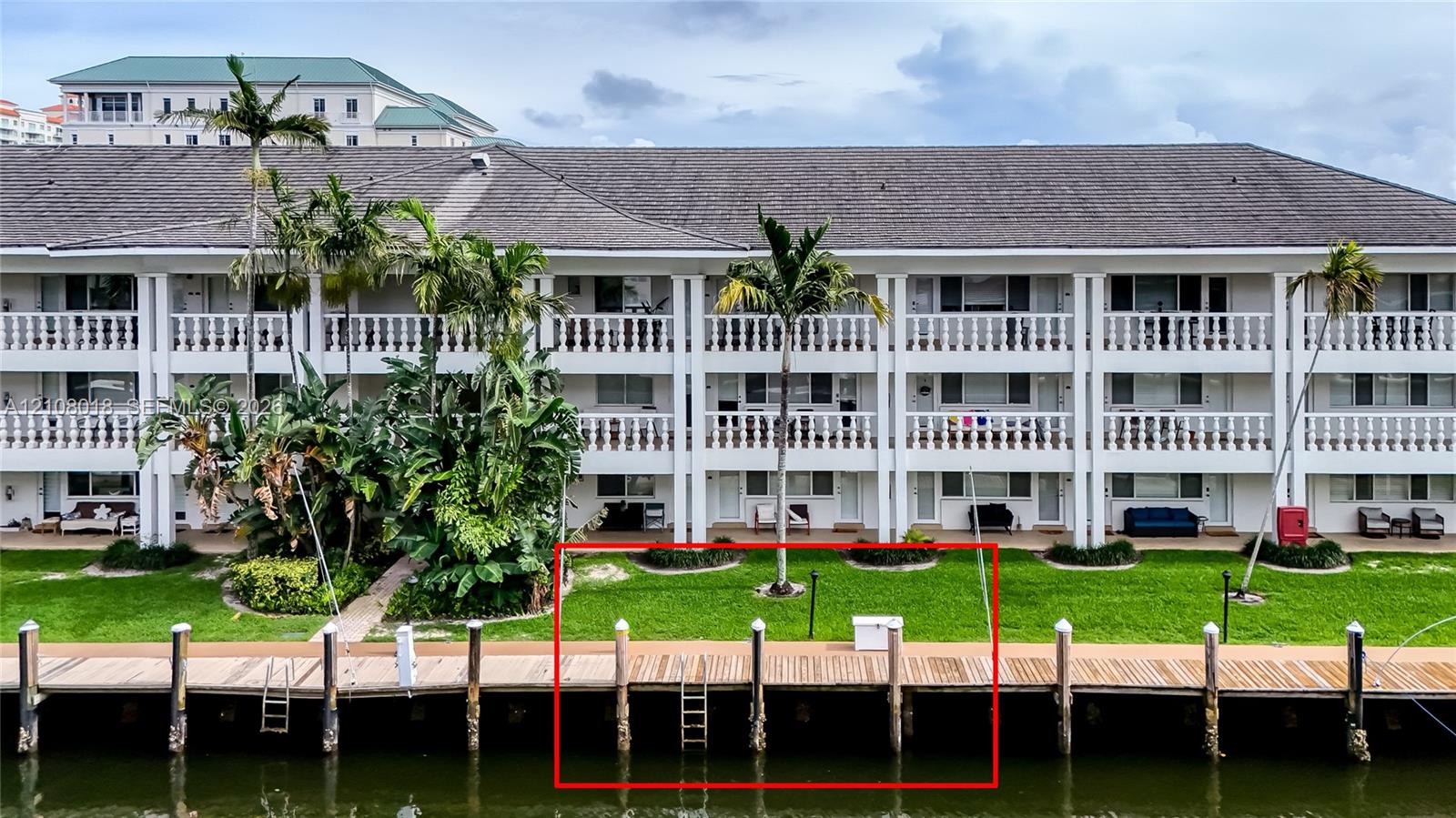 Waterfront wood-plank dock featuring built-in ladder access and piling supports