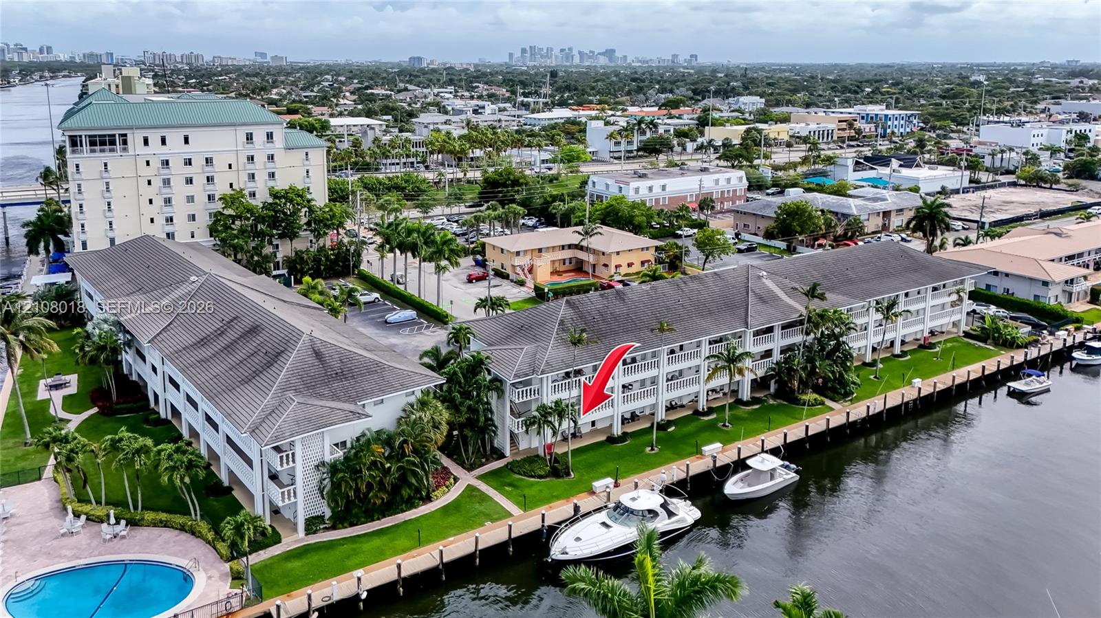 Waterfront condominium featuring deep-water dockage, ground-level green space, and multi-story balcony access along the canal