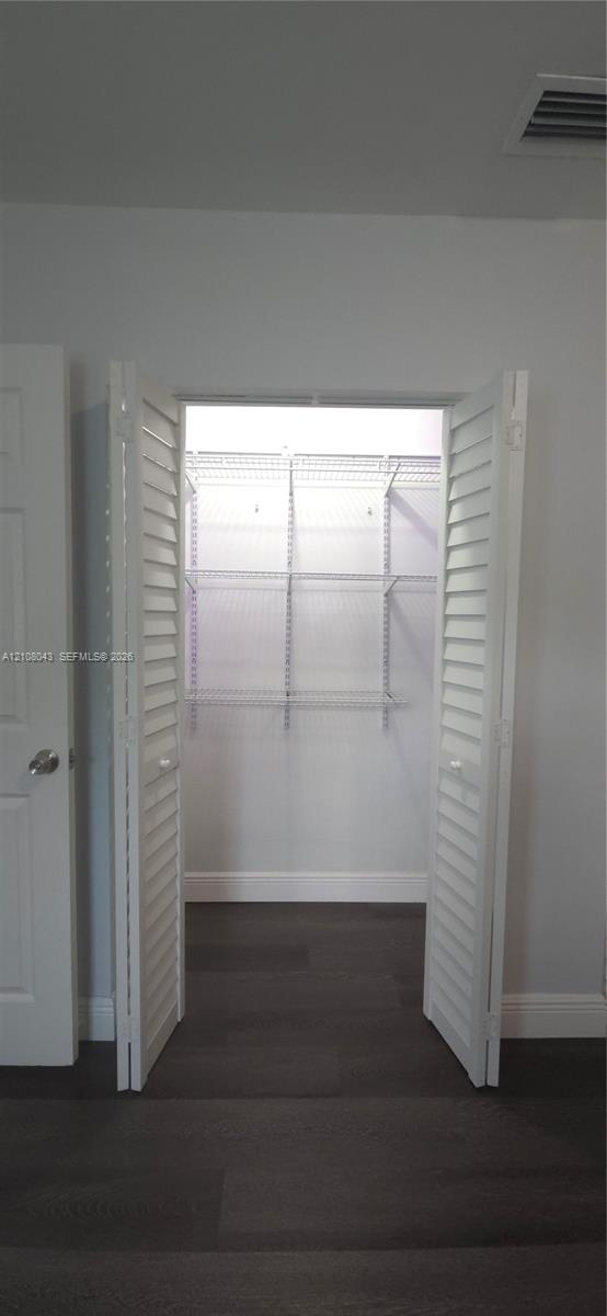 Closet featuring white louvered bifold doors and integrated white wire shelving