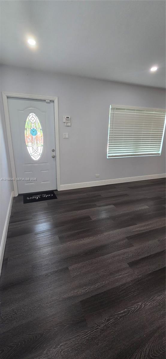 Entryway featuring wood-finish flooring, recessed lighting, and an exterior door with an oval stained-glass insert