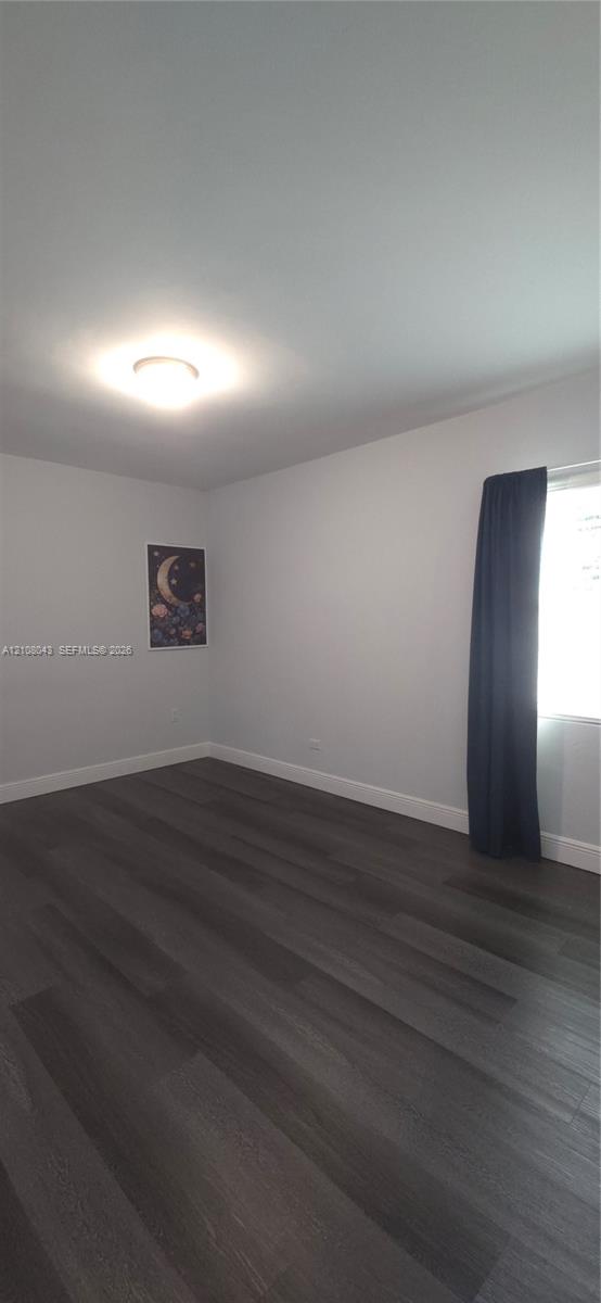 Neutral-toned walls, wood-finish flooring, and flush-mount ceiling lighting
