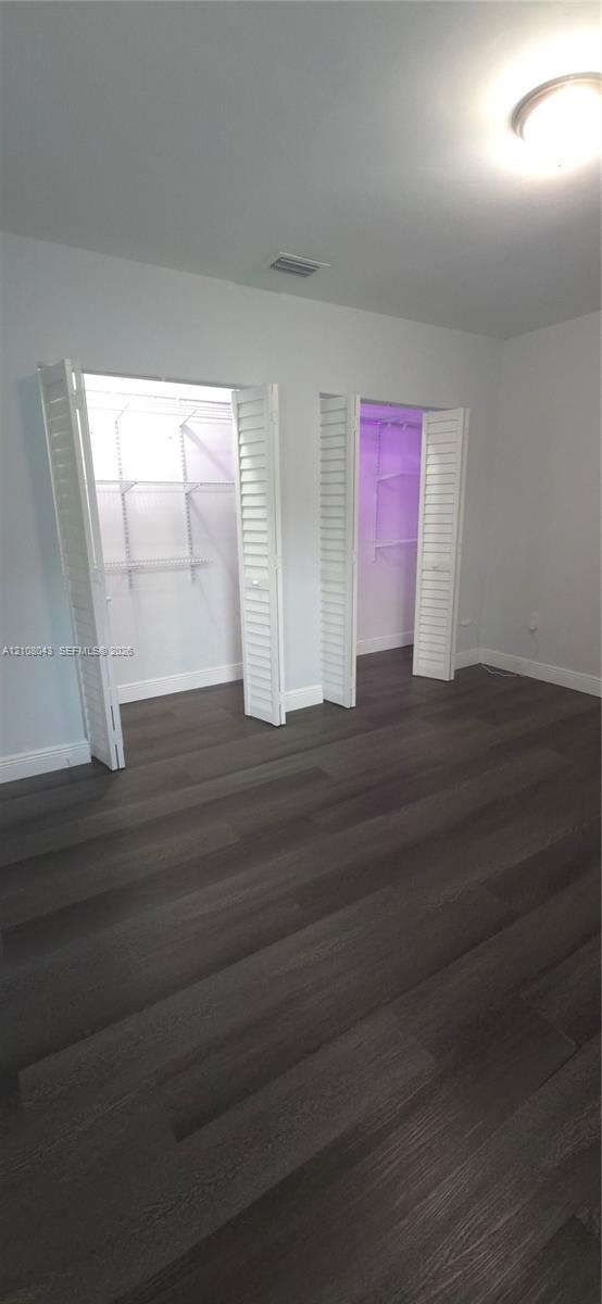 Wood-finish flooring, dual closets with louvered doors, and built-in wire shelving