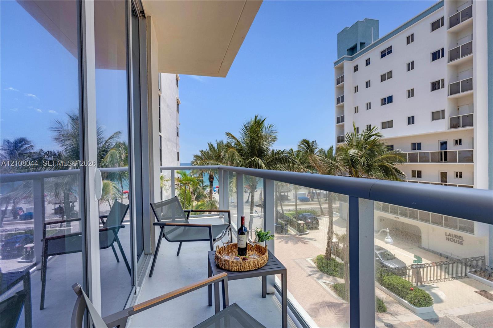 Private balcony featuring glass-panel railings and sliding glass door access