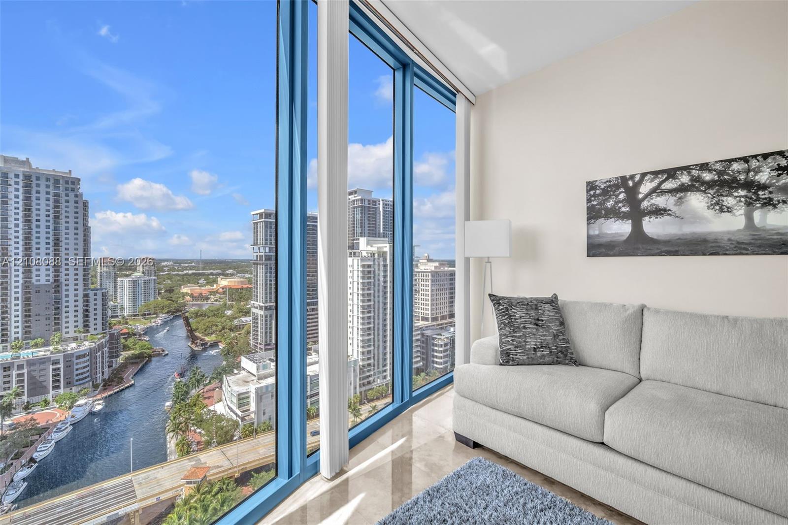 Floor-to-ceiling windows featuring panoramic urban scenery and polished tile flooring