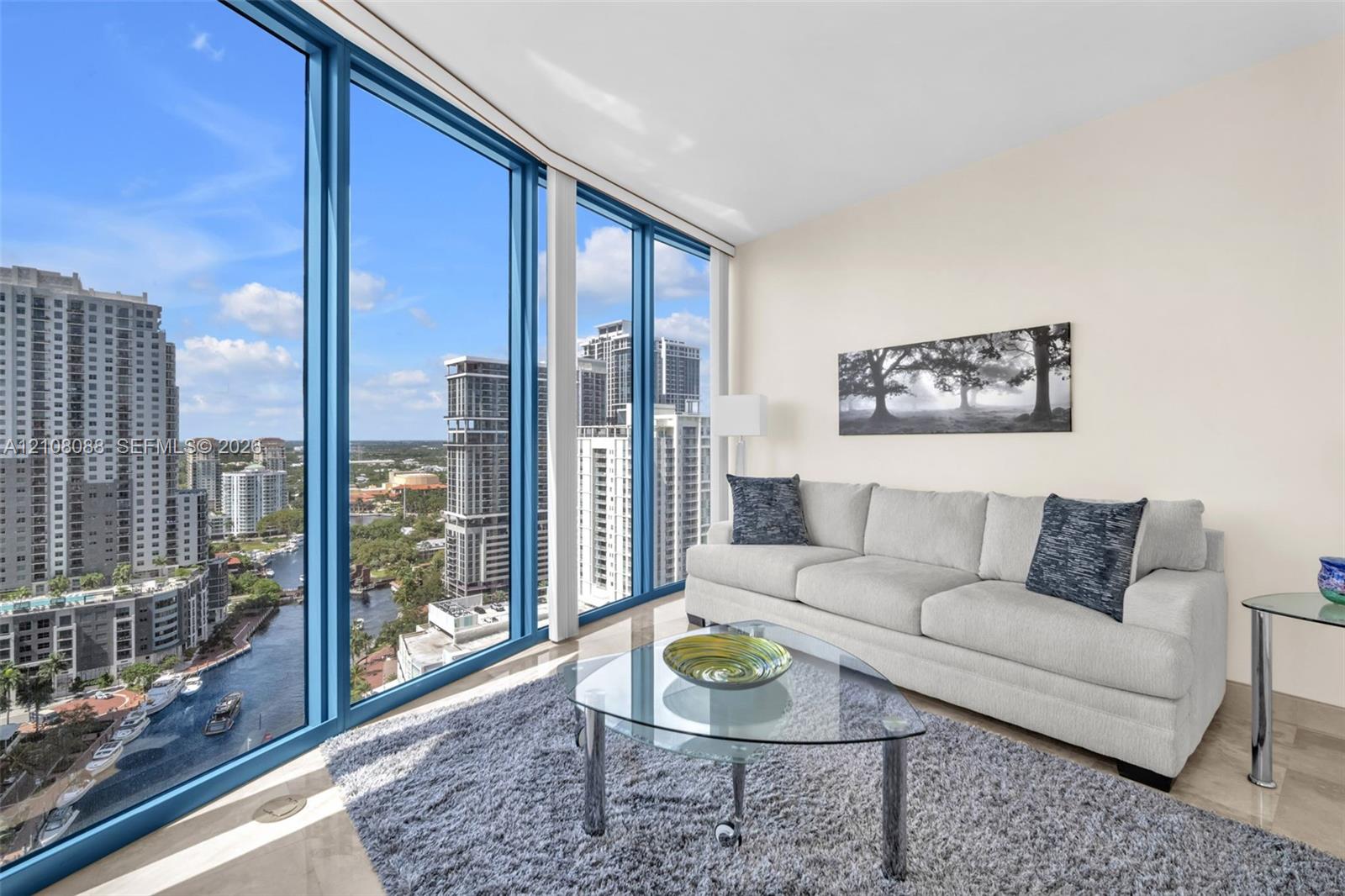 Floor-to-ceiling windows featuring panoramic urban scenery and stone-finish flooring