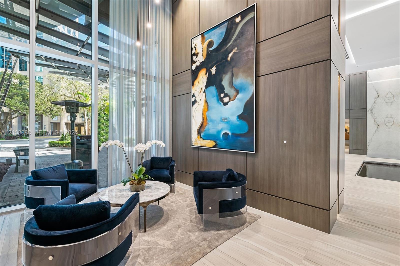 Floor-to-ceiling windows, wood-finish paneling, stone-finish flooring, and integrated recessed lighting