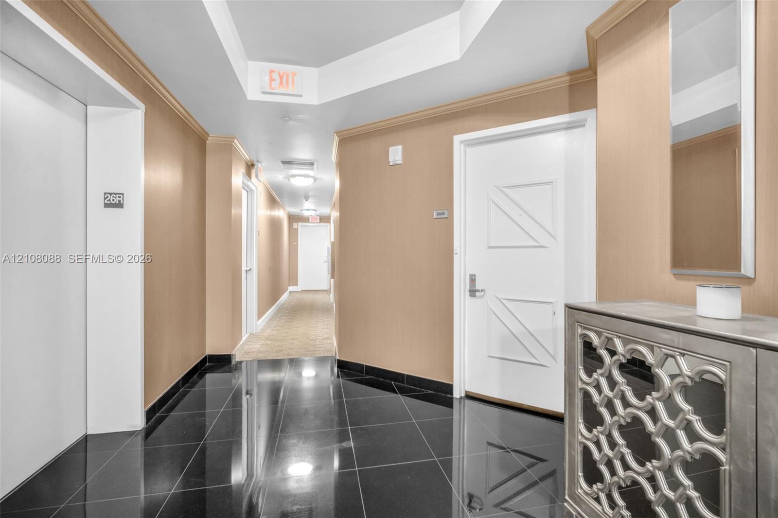 Semi Private Foyer Polished black tile flooring, beige wall surfacing, recessed tray ceiling, and white paneled doors Semi Private Foyer Polished black tile flooring, beige wall surfacing, recessed tray ceiling, and white paneled doors