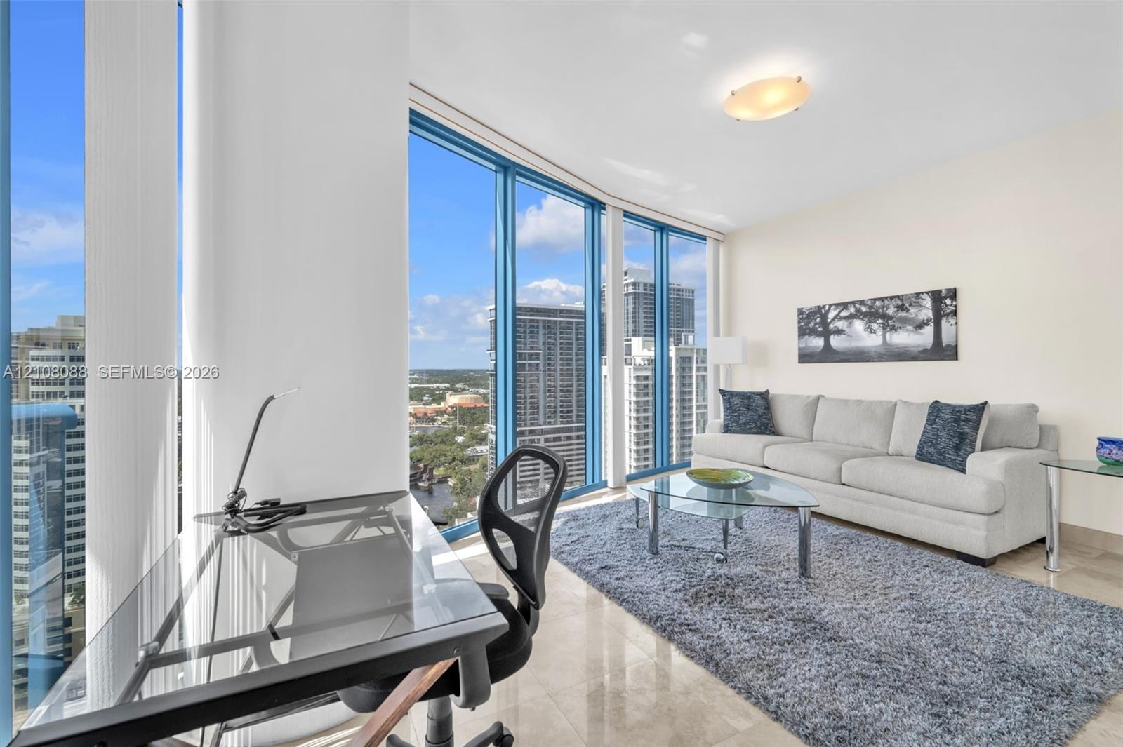 Floor-to-ceiling windows, polished stone flooring, and a flush-mount ceiling light fixture