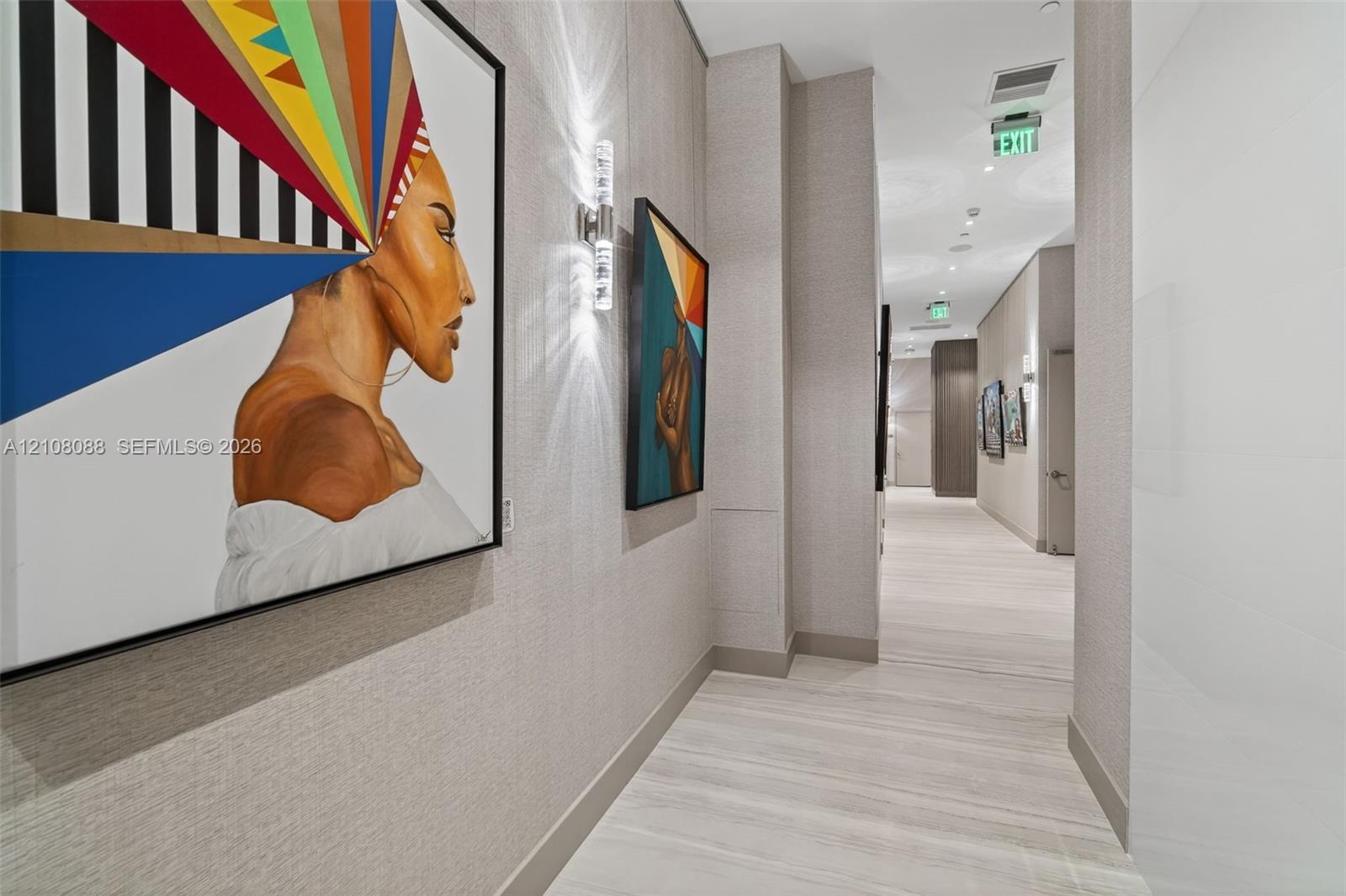 Textured wall covering, wood-finish flooring, and wall-mounted cylindrical light fixtures