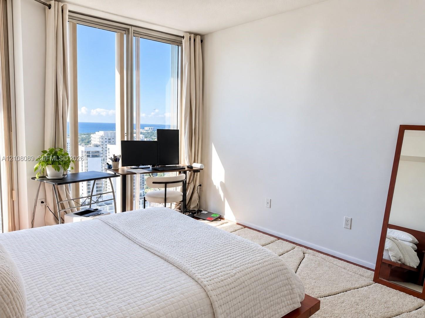 Floor-to-ceiling windows featuring expansive coastal and urban scenery