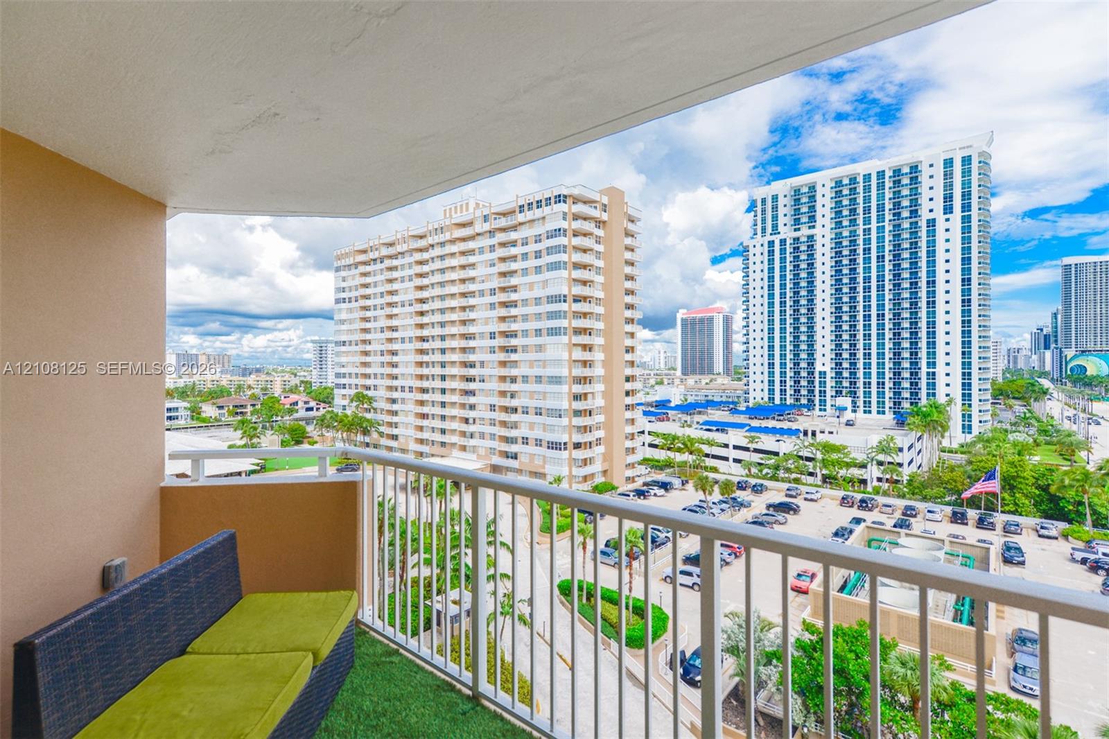 Private balcony featuring a white metal railing and a concrete floor