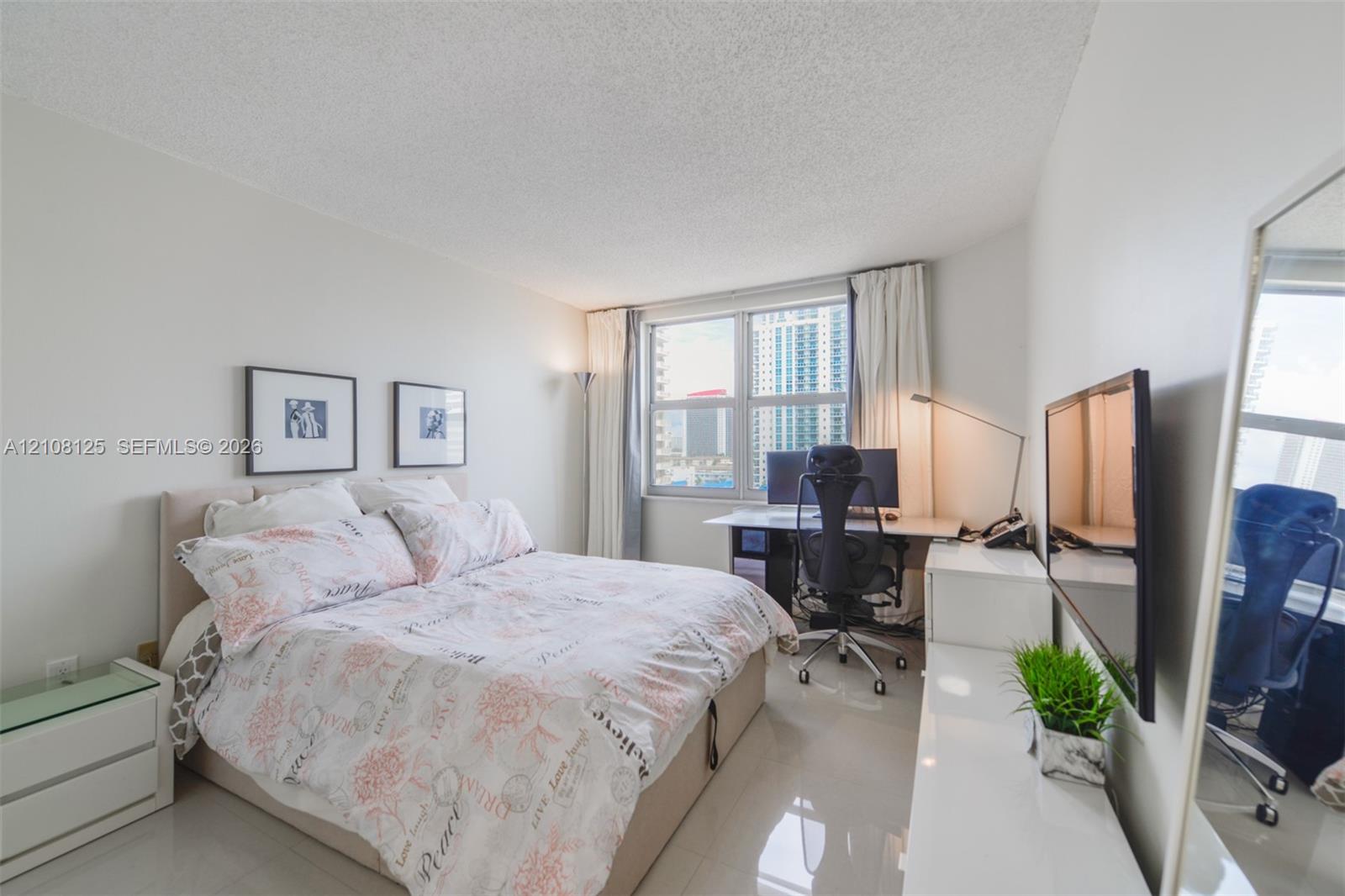 Bright room featuring large windows, high-gloss tile flooring, and neutral wall tones
