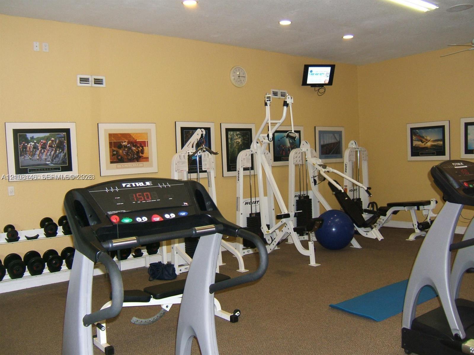 Interior space featuring recessed lighting, wall-mounted display electronics, and neutral carpeting