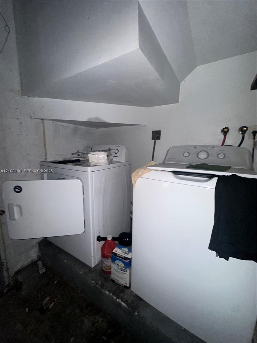 Dedicated laundry area featuring dual water hookups and an elevated concrete platform
