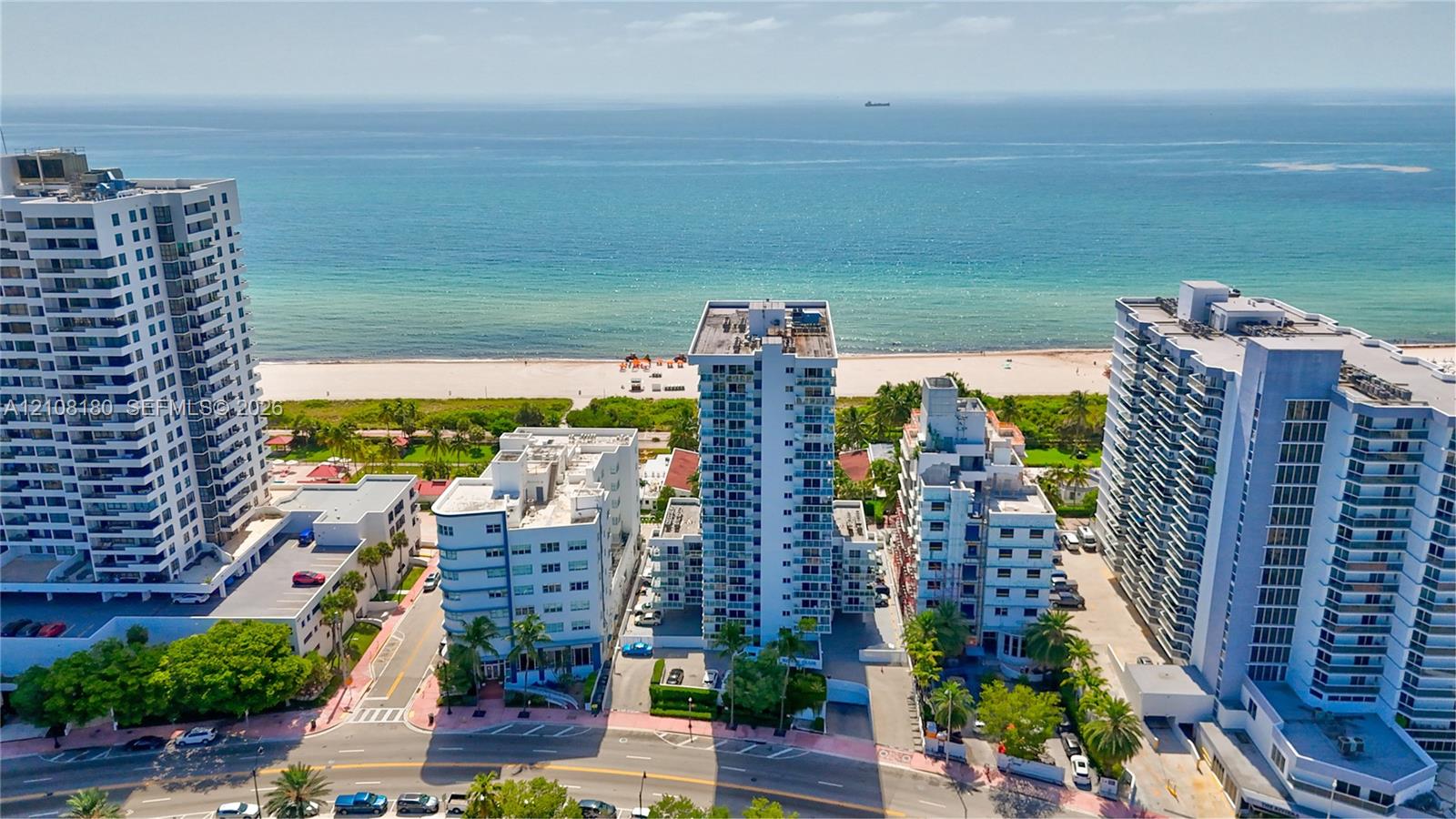 Aerial perspective featuring high-rise coastal architecture with balconies and direct proximity to the sandy shoreline and oceanfront Aerial perspective featuring high-rise coastal architecture with balconies and direct proximity to the sandy shoreline and oceanfront