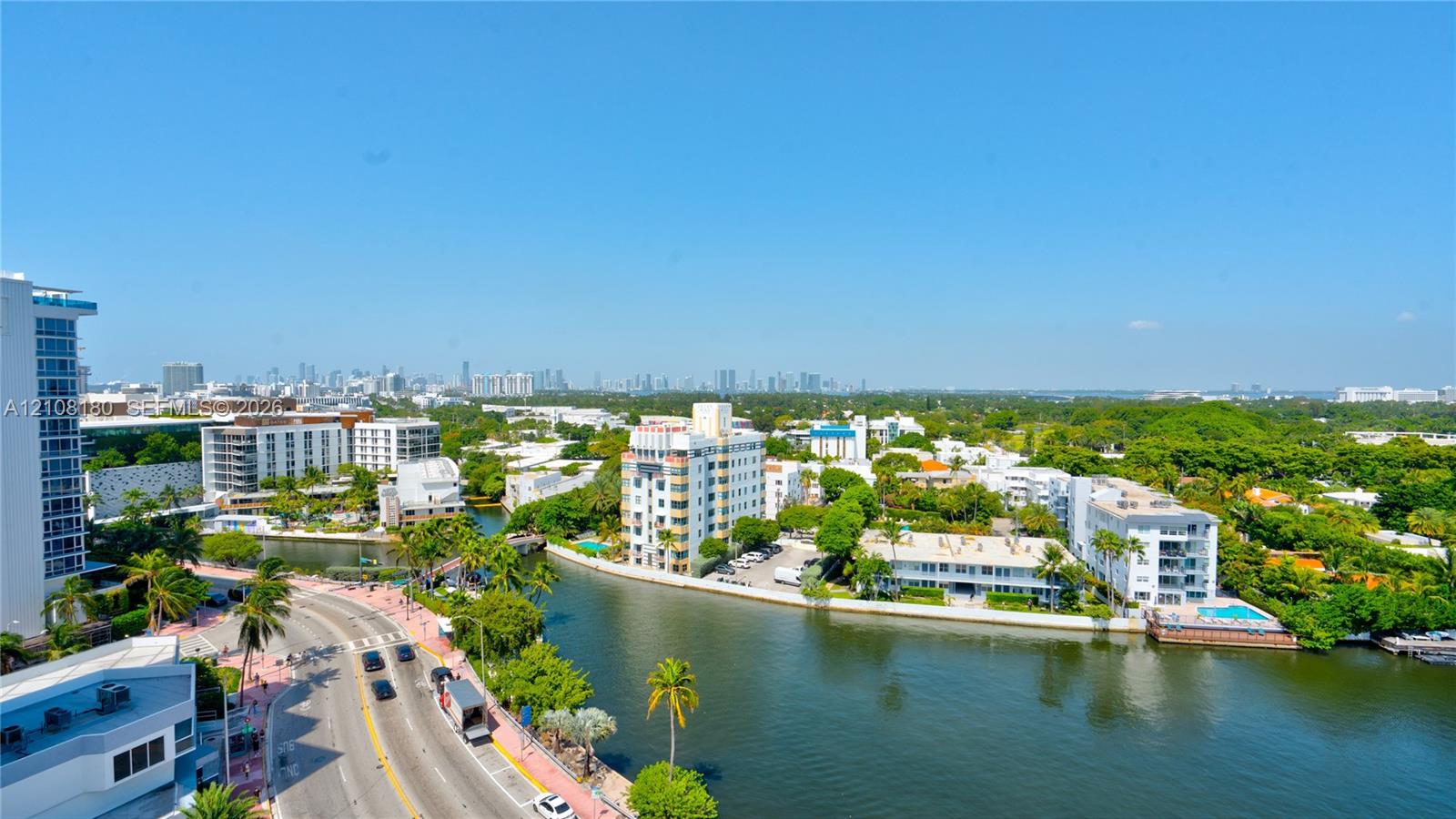 High-altitude perspective featuring coastal waterway, cityscape skyline, surrounding lush canopy, and street-level thoroughfare