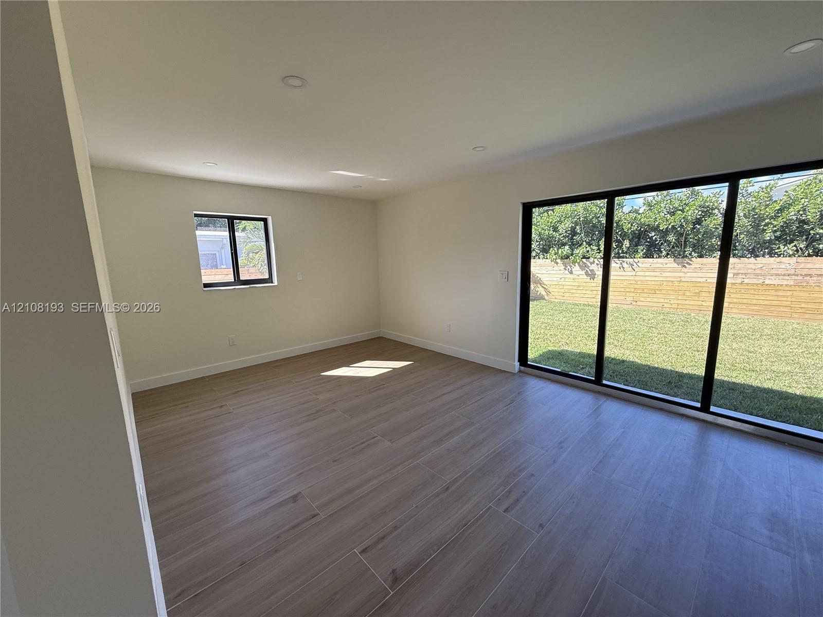 Interior featuring wood-finish flooring, recessed lighting, and expansive glass sliding doors