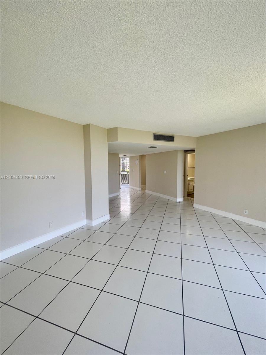 Interior space featuring large-format diagonal tile flooring and neutral wall tones