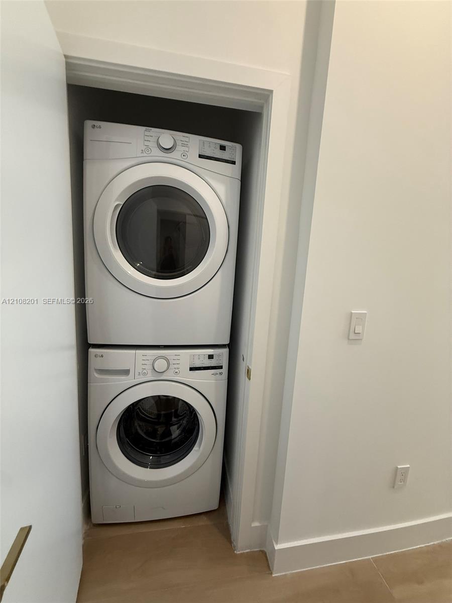 Stacked white front-load washer and dryer set Stacked white front-load washer and dryer set
