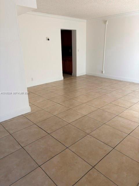 Neutral-toned ceramic tile flooring, clean white walls, and structured doorways