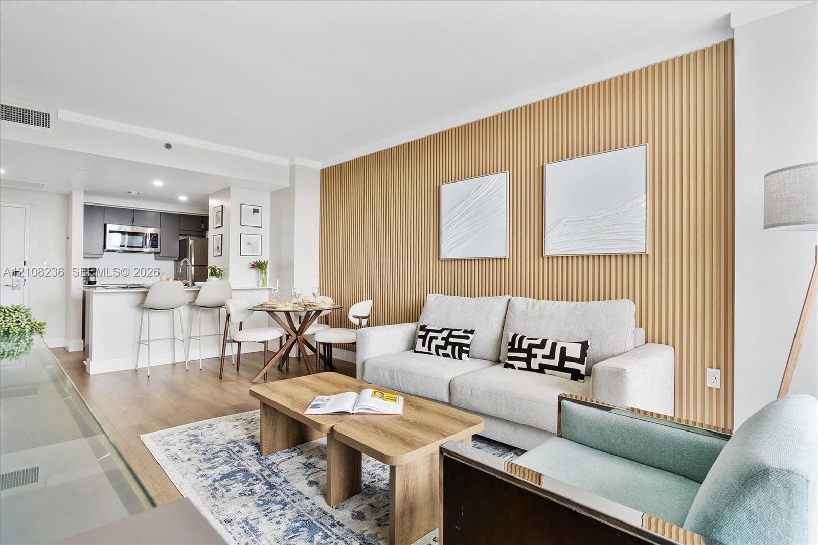 Vertical slat wood-finish accent wall, wood-finish flooring, and recessed ceiling lighting