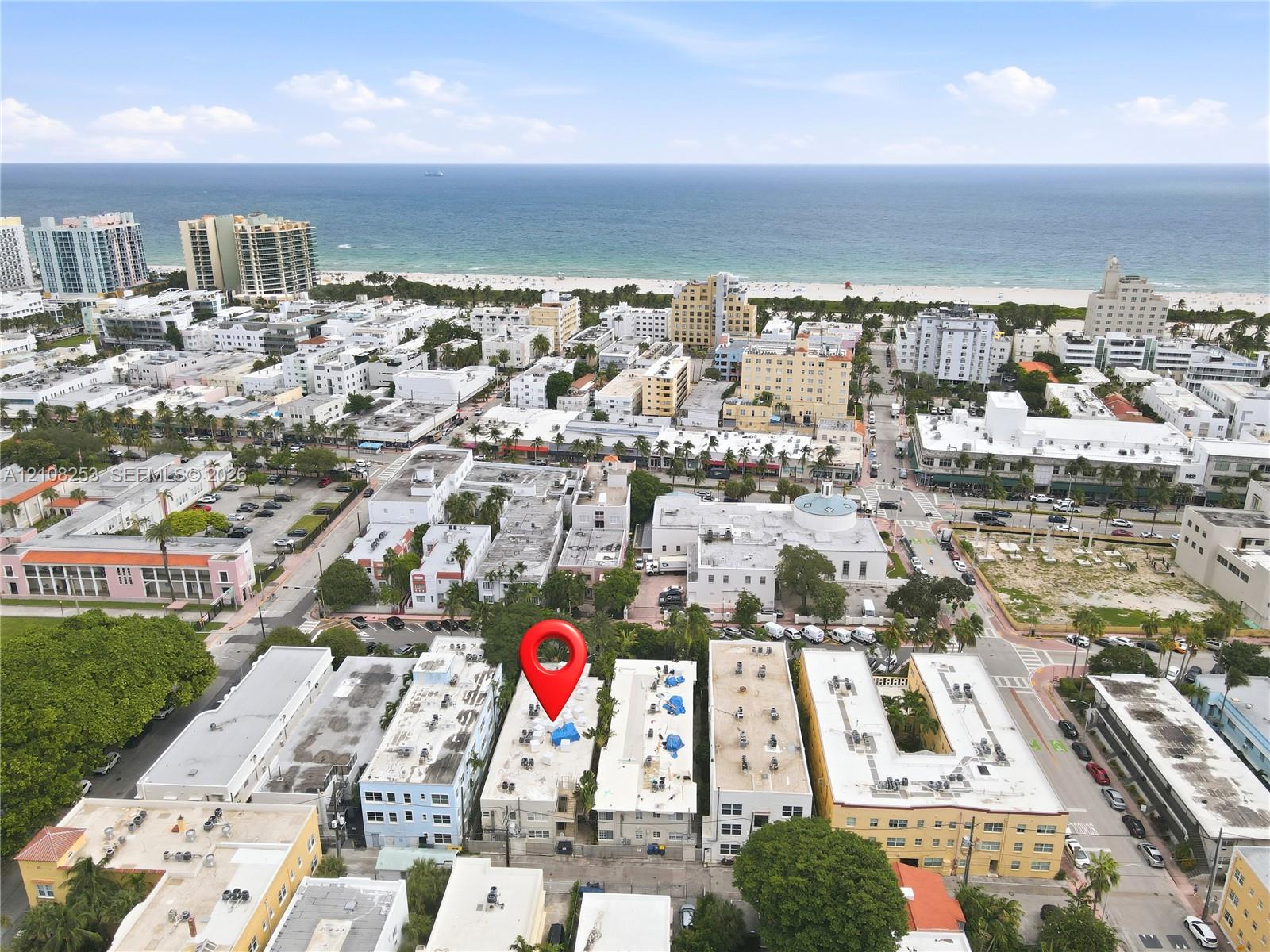 Aerial perspective featuring a multi-story urban building situated in a coastal metropolitan setting
