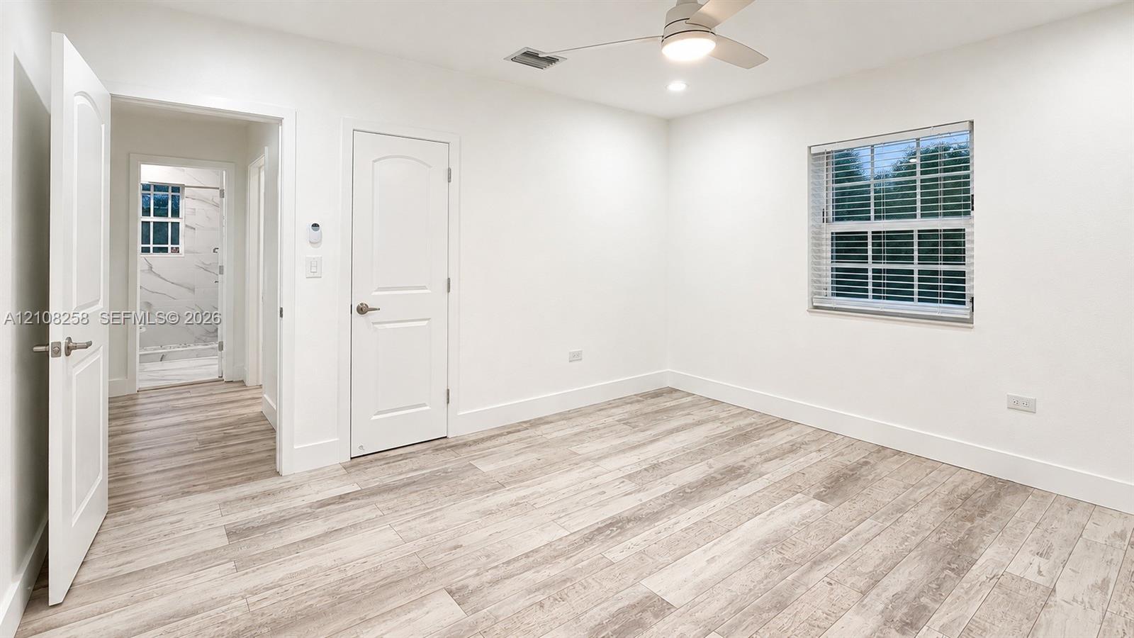 Room featuring wood-finish flooring, recessed lighting, a ceiling fan, and multi-pane window