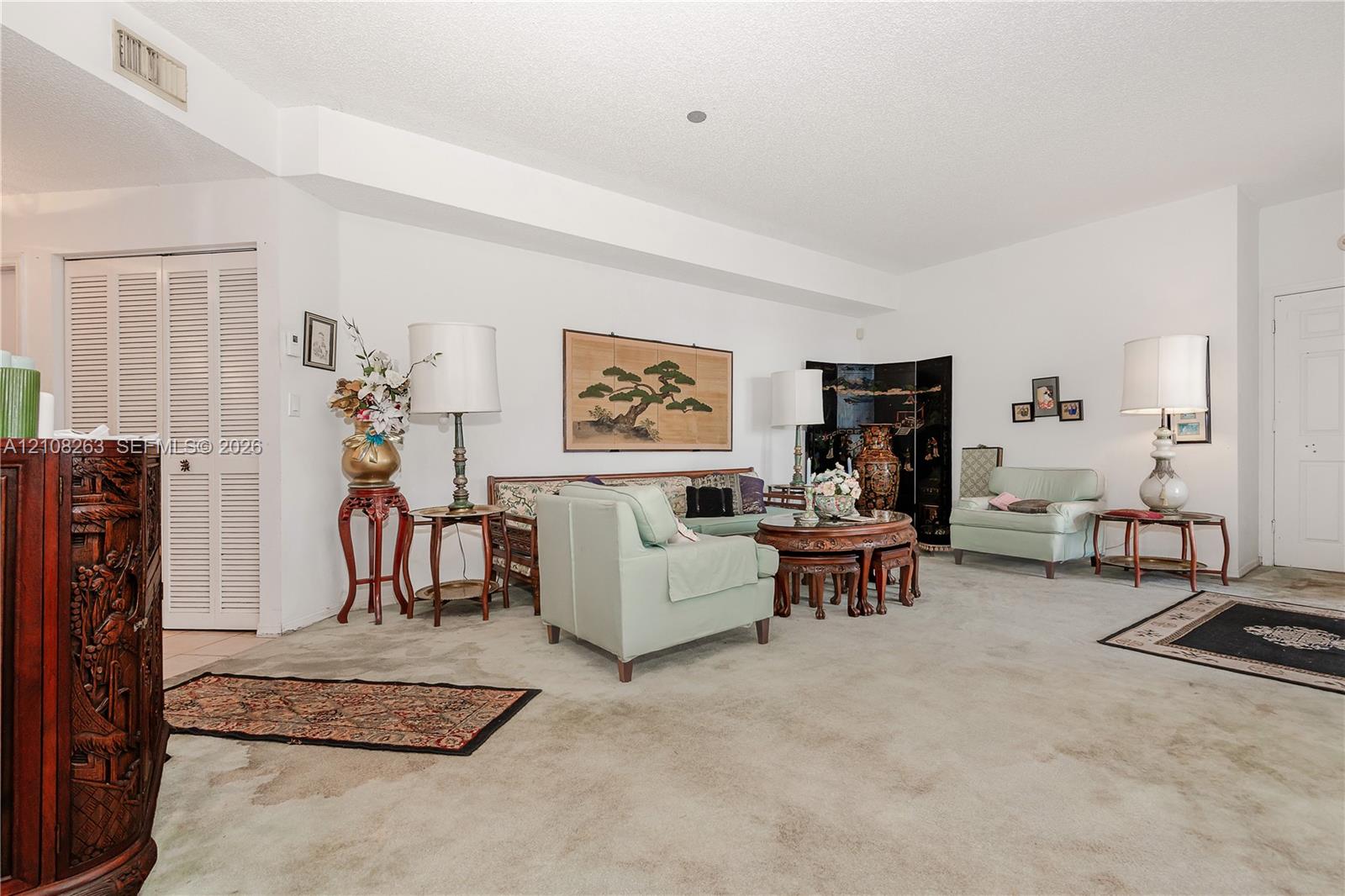 Spacious interior featuring neutral wall tones, clean lines, and louvered closet doors