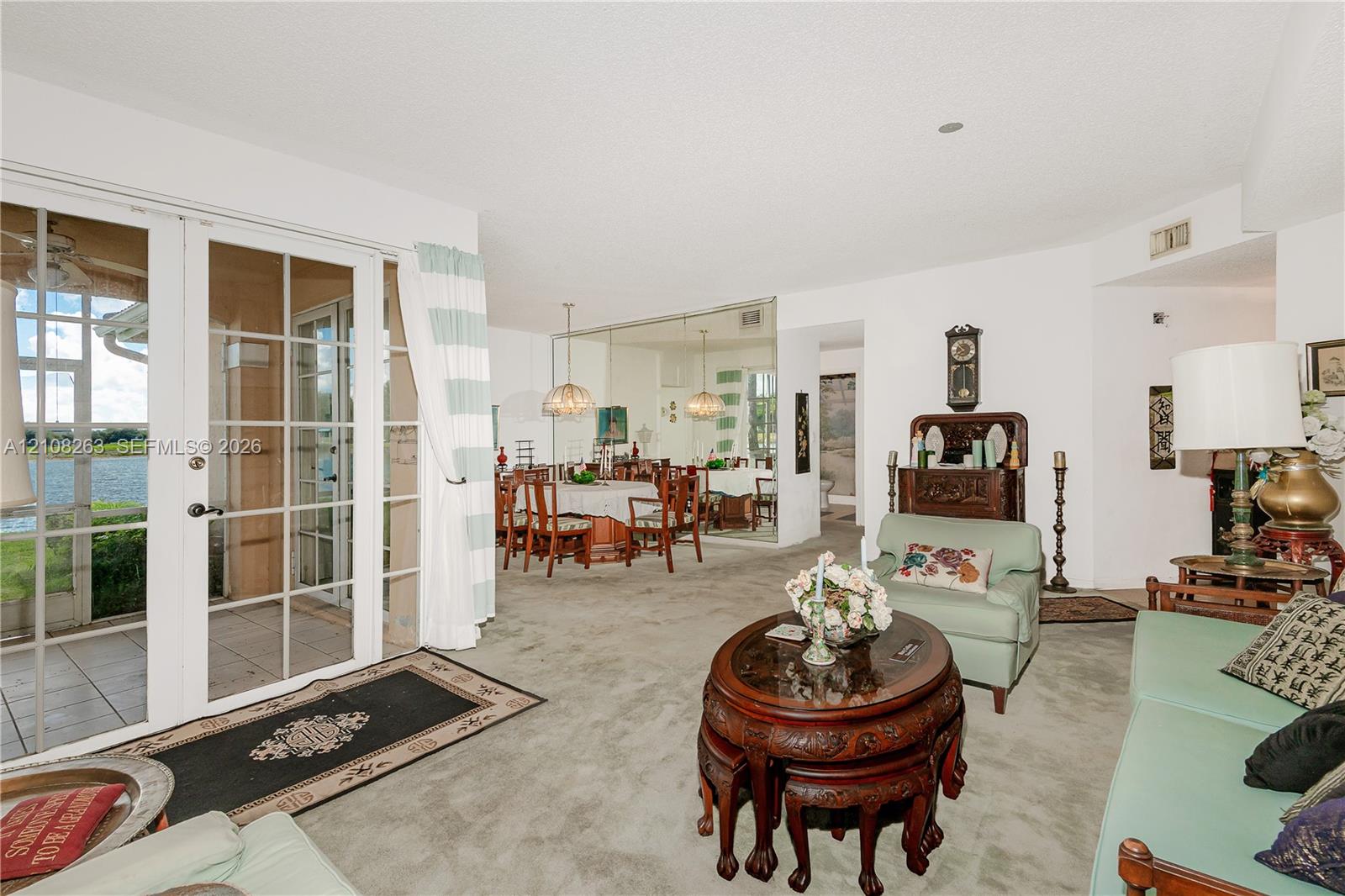 Full-height glass panel doors, mirrored wall, and recessed ceiling lighting