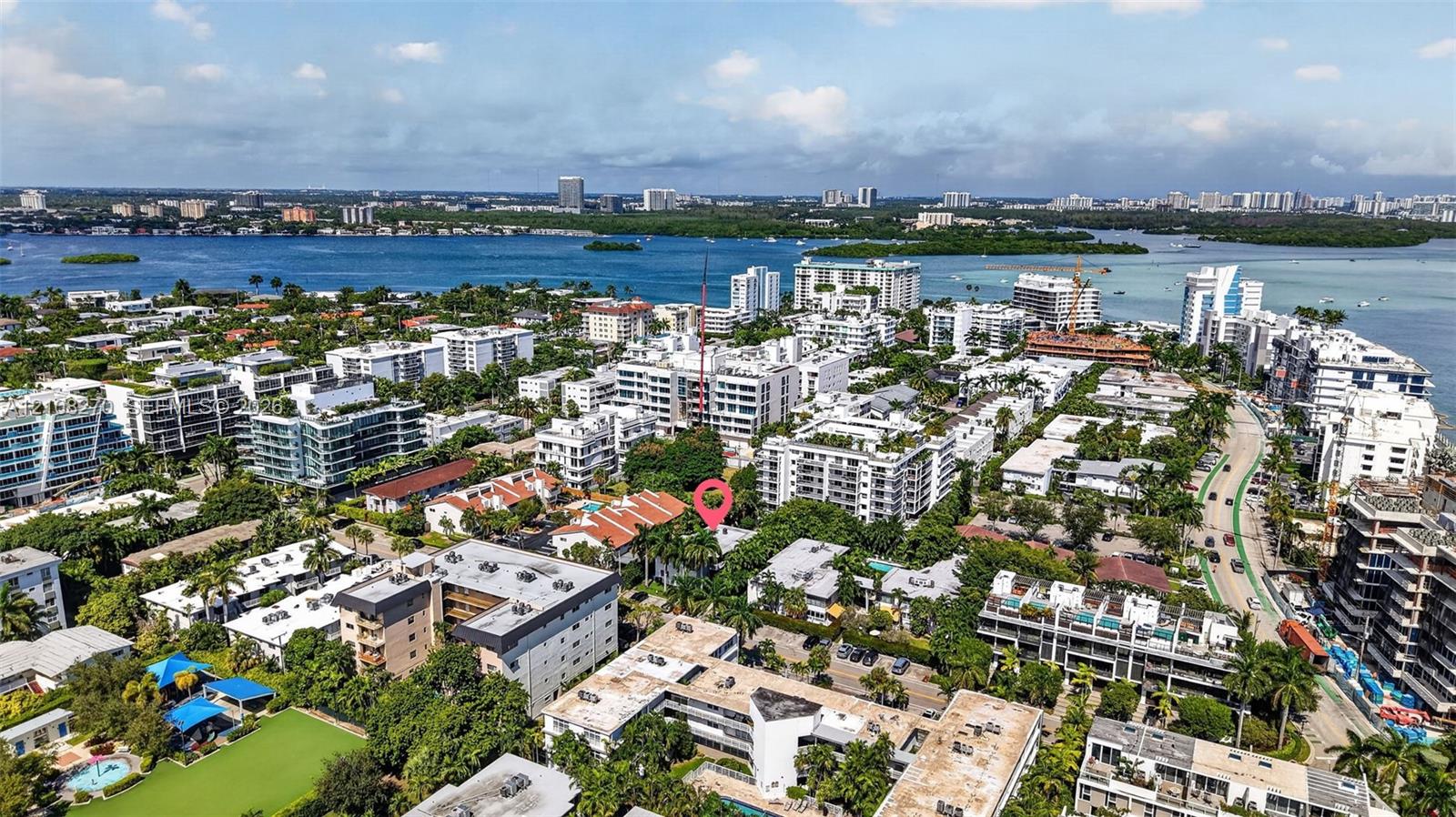 Aerial perspective of the property location, characterized by mature tropical landscaping, dense residential density, and proximity to coastal waters
