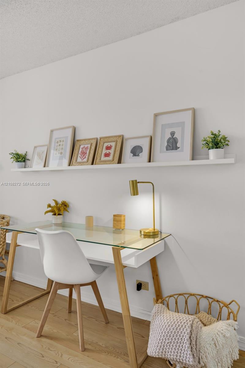Wall-mounted white display ledge and wood-finish flooring