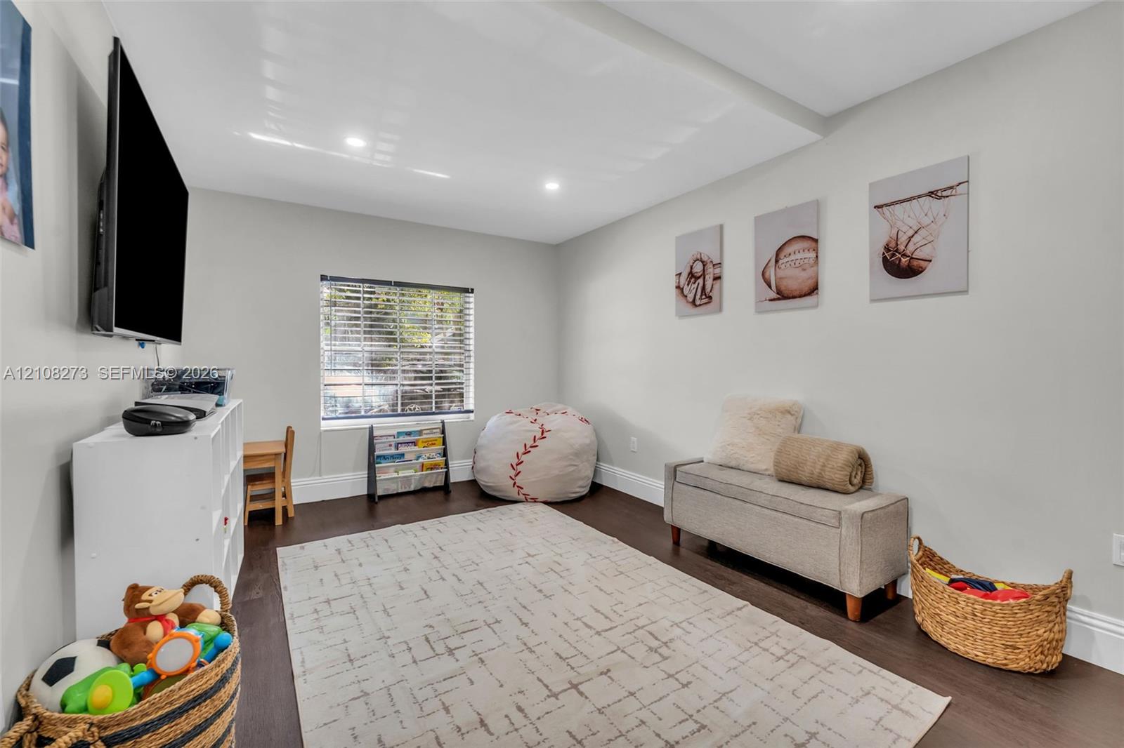 Interior space featuring recessed lighting, wood-finish flooring, and a single window with horizontal blinds
