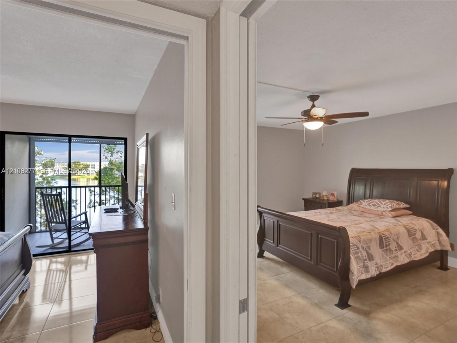 Tile flooring throughout, ceiling fan with light fixture, and sliding glass door opening to a screened balcony