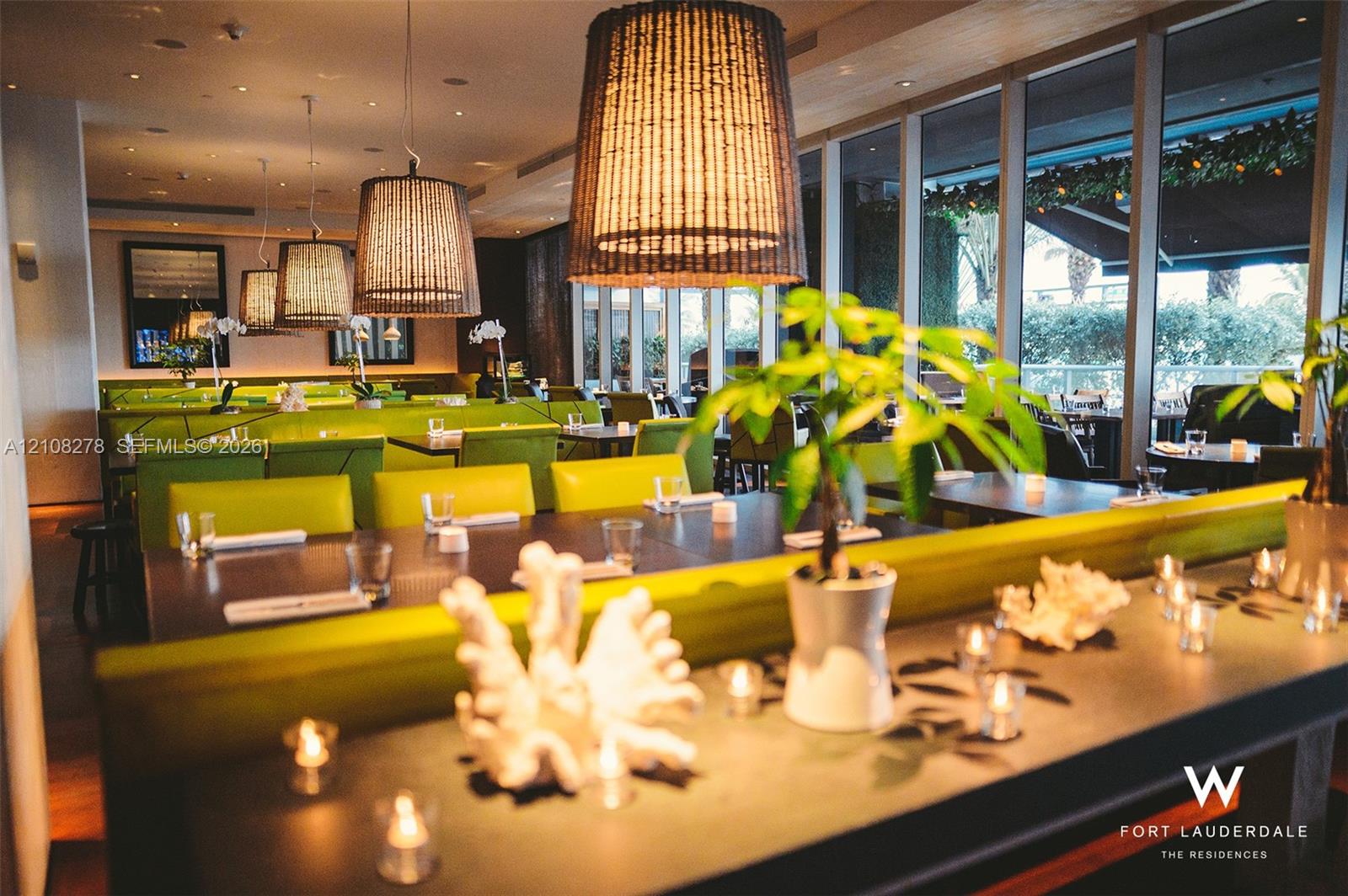 Floor-to-ceiling windows, custom built-in bench seating, pendant lighting, and recessed ceiling lighting