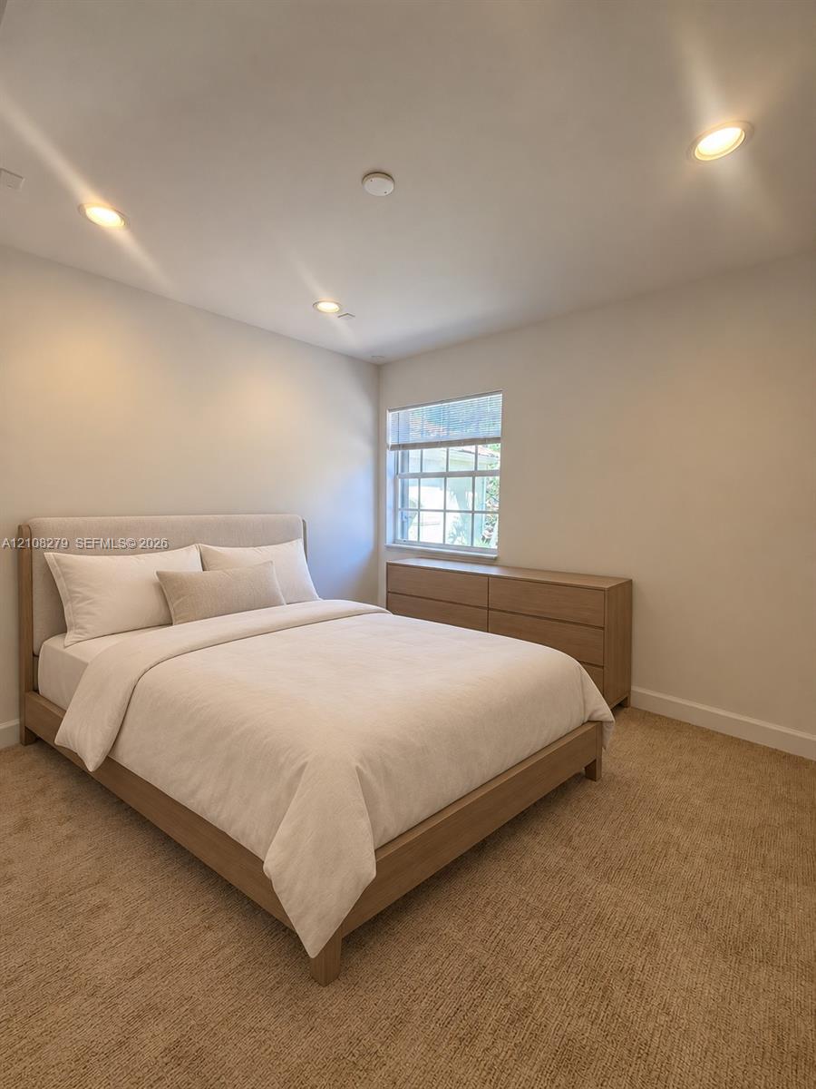 Neutral-toned interior featuring recessed lighting, wall-to-wall carpeting, and a multi-pane window
