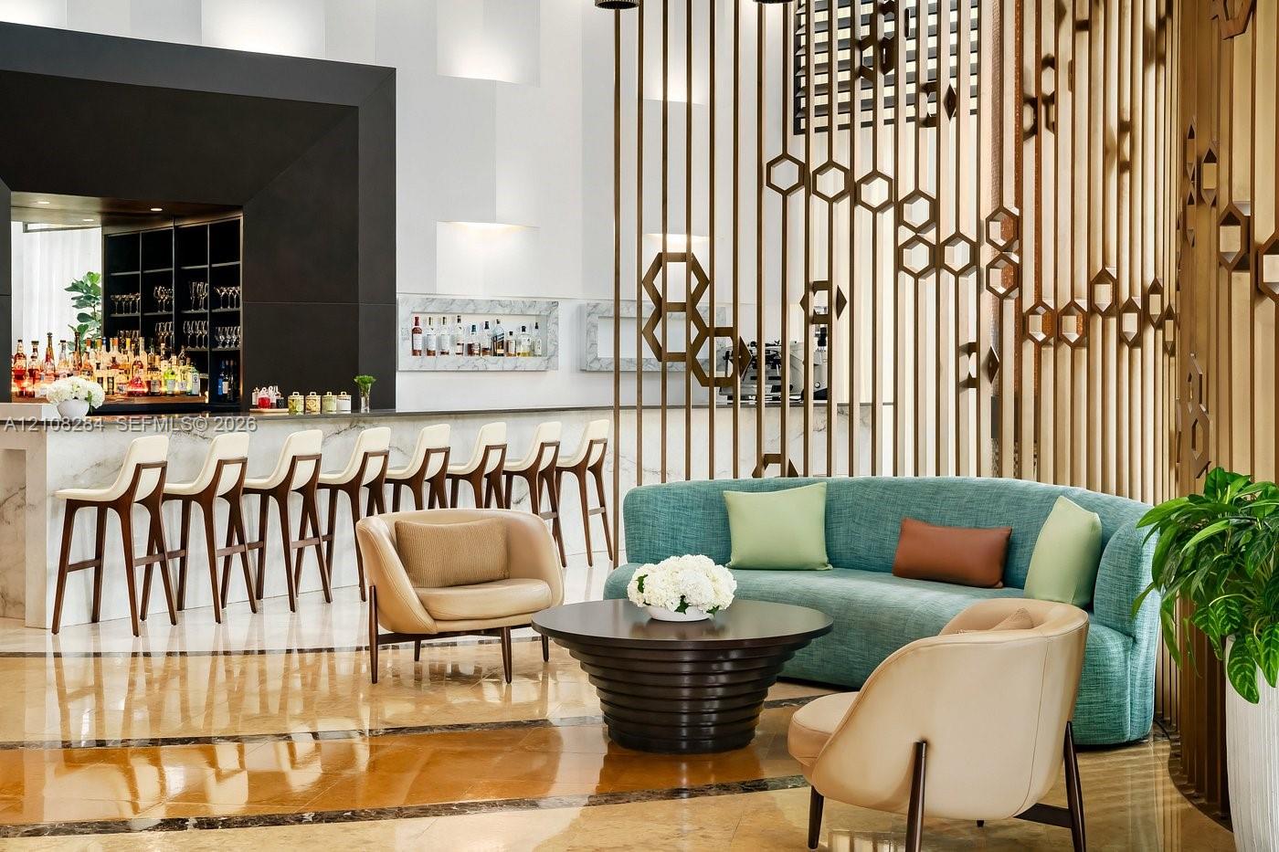 Bar area featuring a stone-surface counter, geometric metal room partition, recessed wall shelving, and polished stone-finish flooring