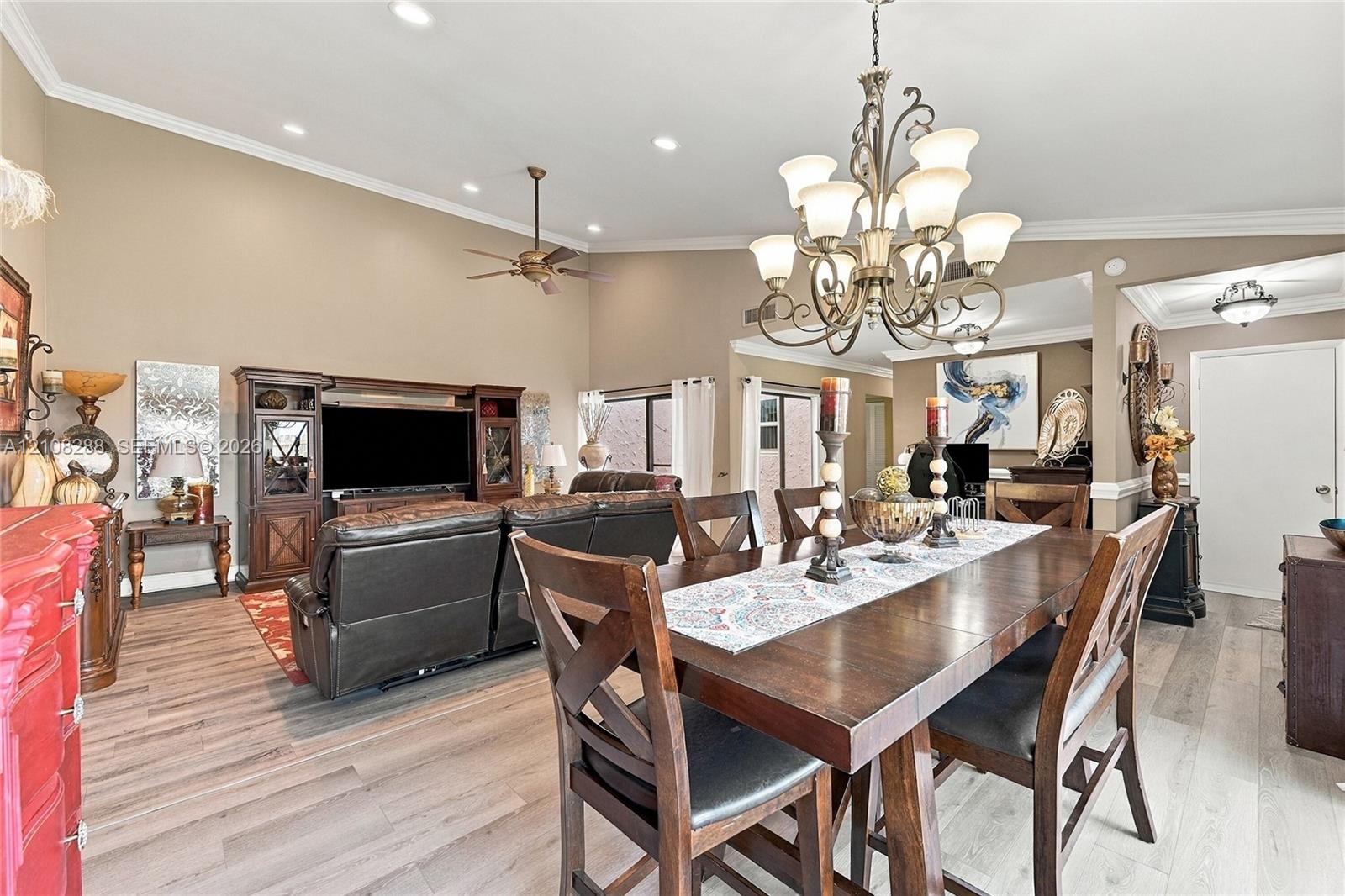 Vaulted ceilings with recessed lighting, wood-finish flooring, and an ornate multi-arm chandelier Vaulted ceilings with recessed lighting, wood-finish flooring, and an ornate multi-arm chandelier