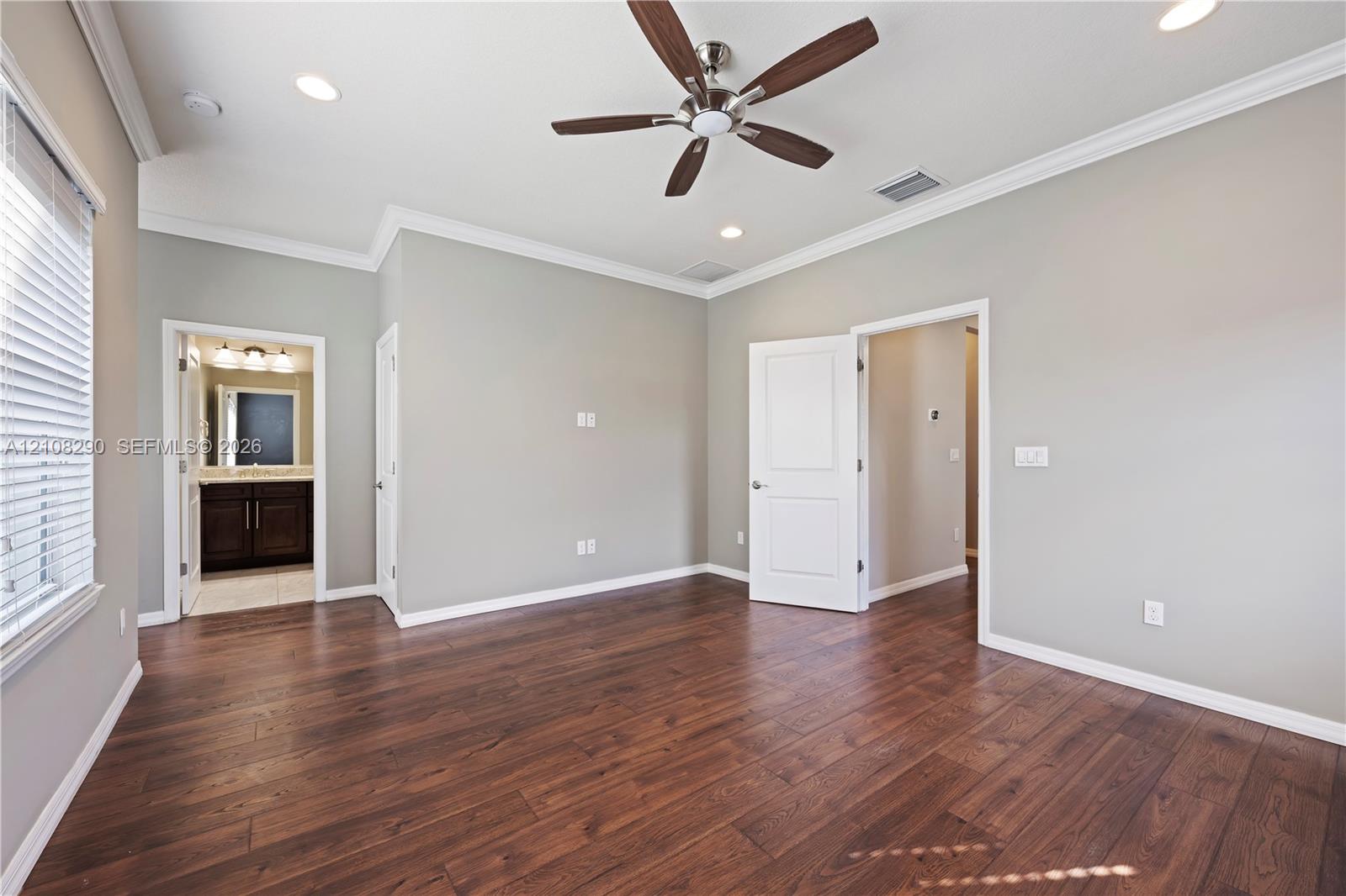 Room featuring wood-finish flooring, crown molding, recessed lighting, and a ceiling fan