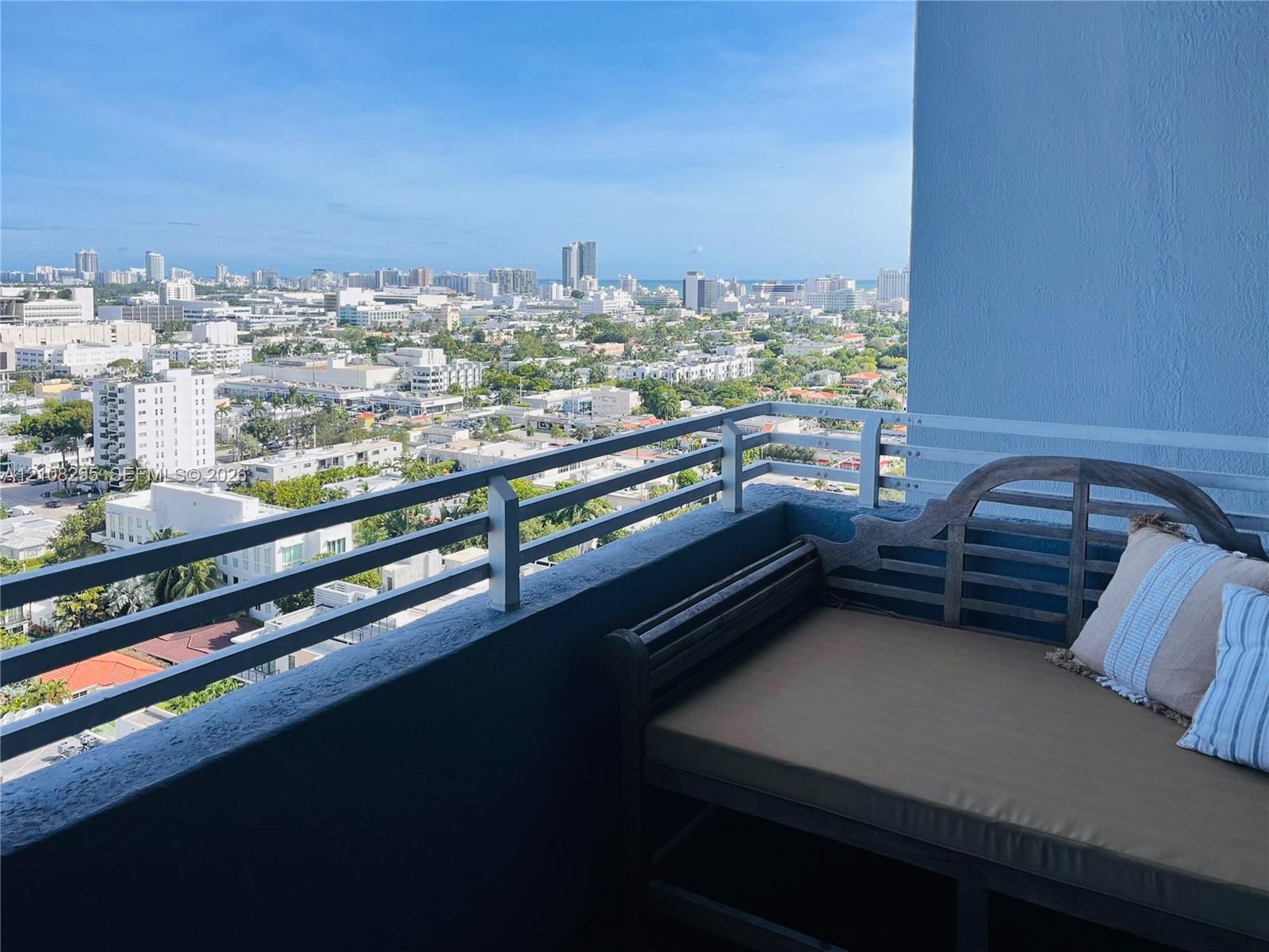 Private balcony with a metal railing and expansive cityscape panorama Private balcony with a metal railing and expansive cityscape panorama