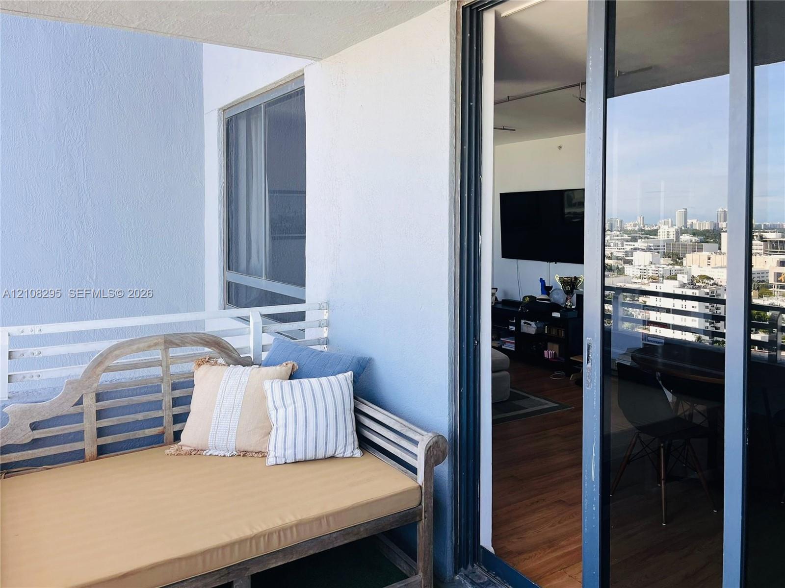 Private balcony featuring a white metal railing and sliding glass door entrance Private balcony featuring a white metal railing and sliding glass door entrance
